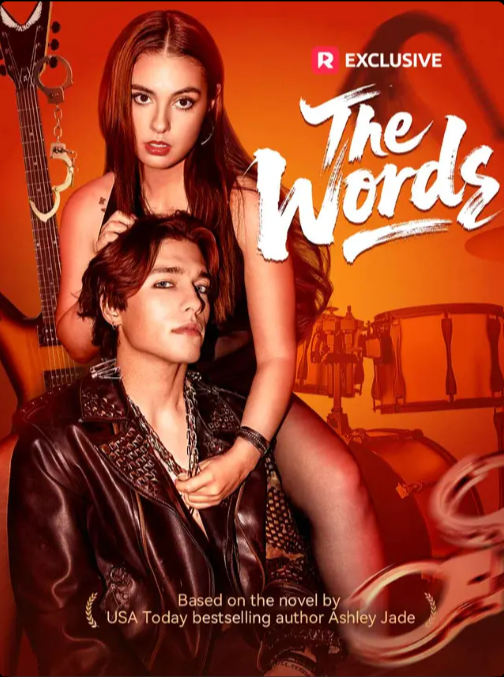 Cover of a book titled "The Words" featuring a woman with long red hair and a man with short brown hair, both posing against an orange background with musical instruments, with the book based on a novel by Ashley Jade.