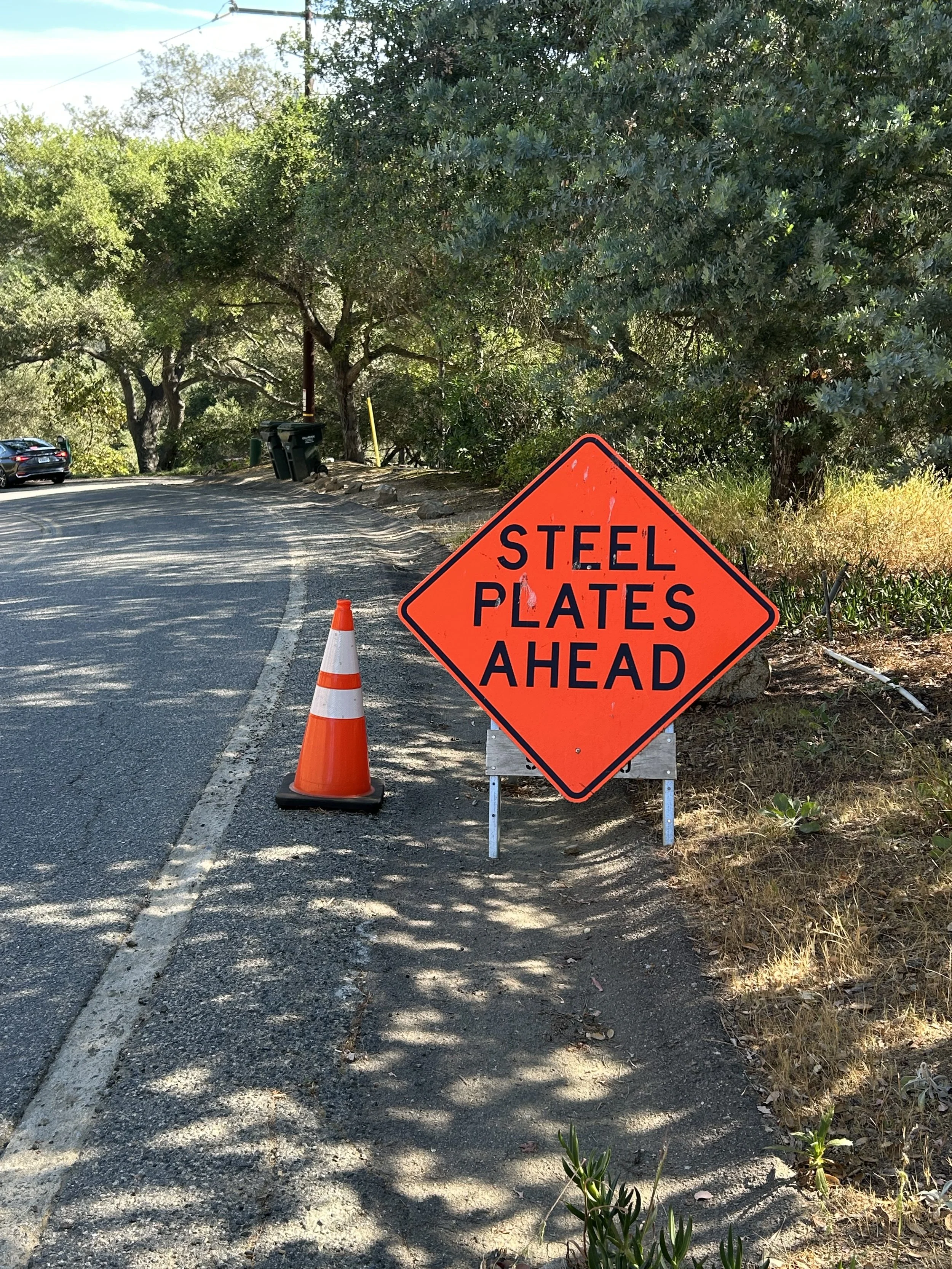 STEEL PLATE RESET AND WARNING SIGN INSTALLED AFTER PRESSURE FROM RESIDENTS