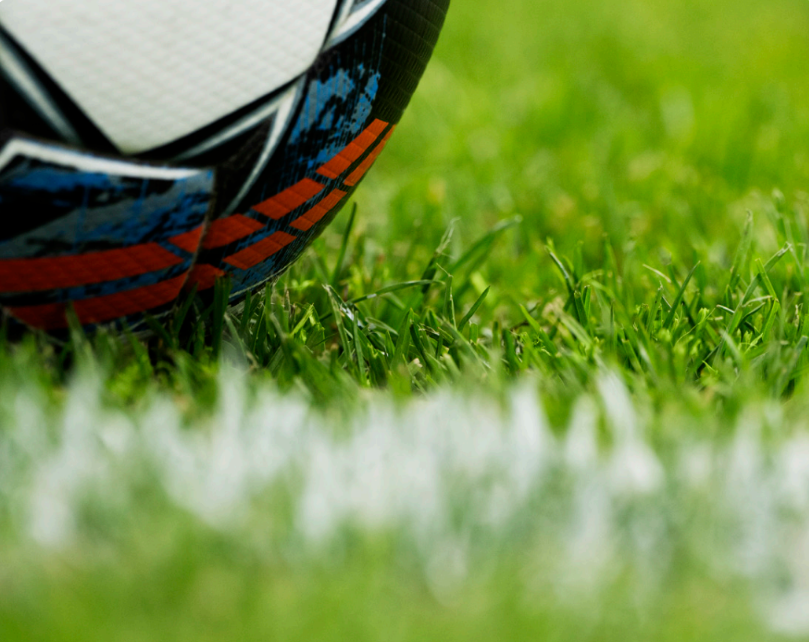 Close-up of a soccer ball on a grassy field
