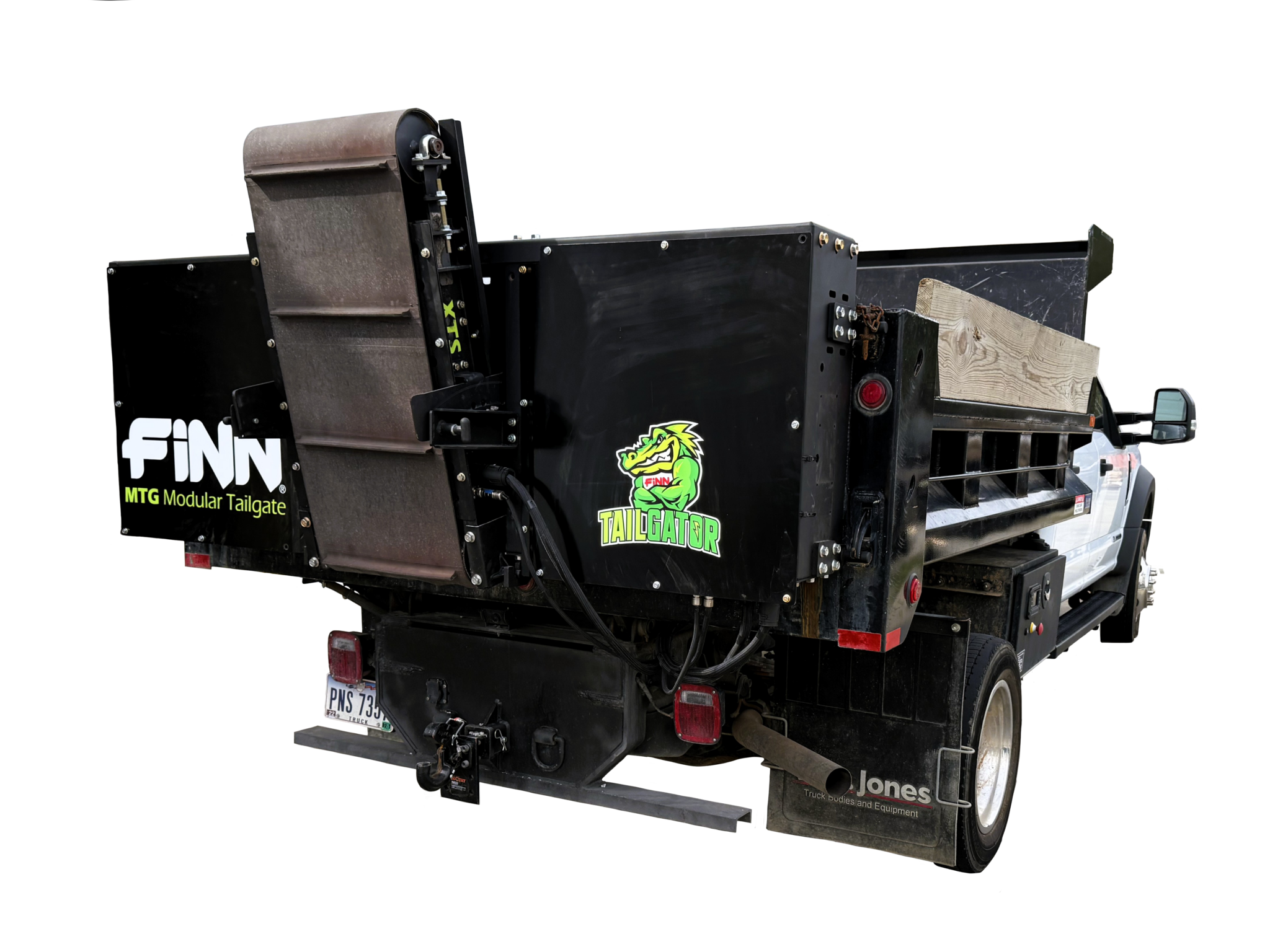 A black truck with a tailgate system labeled 'FINN MTG Modular Tailgate' and a cartoon alligator logo. The truck has a wooden block and various equipment on the flatbed.