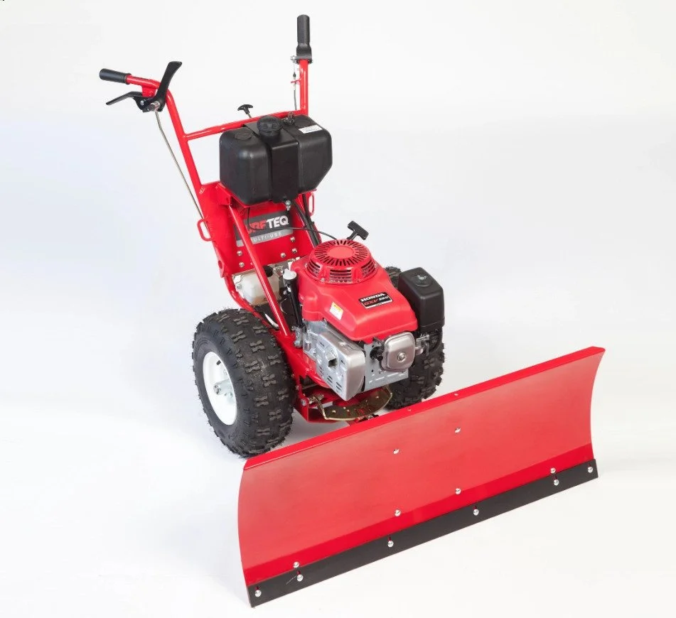 Red snow blower with black engine cover and a wide red and black metal blade in front, positioned on a plain white background.