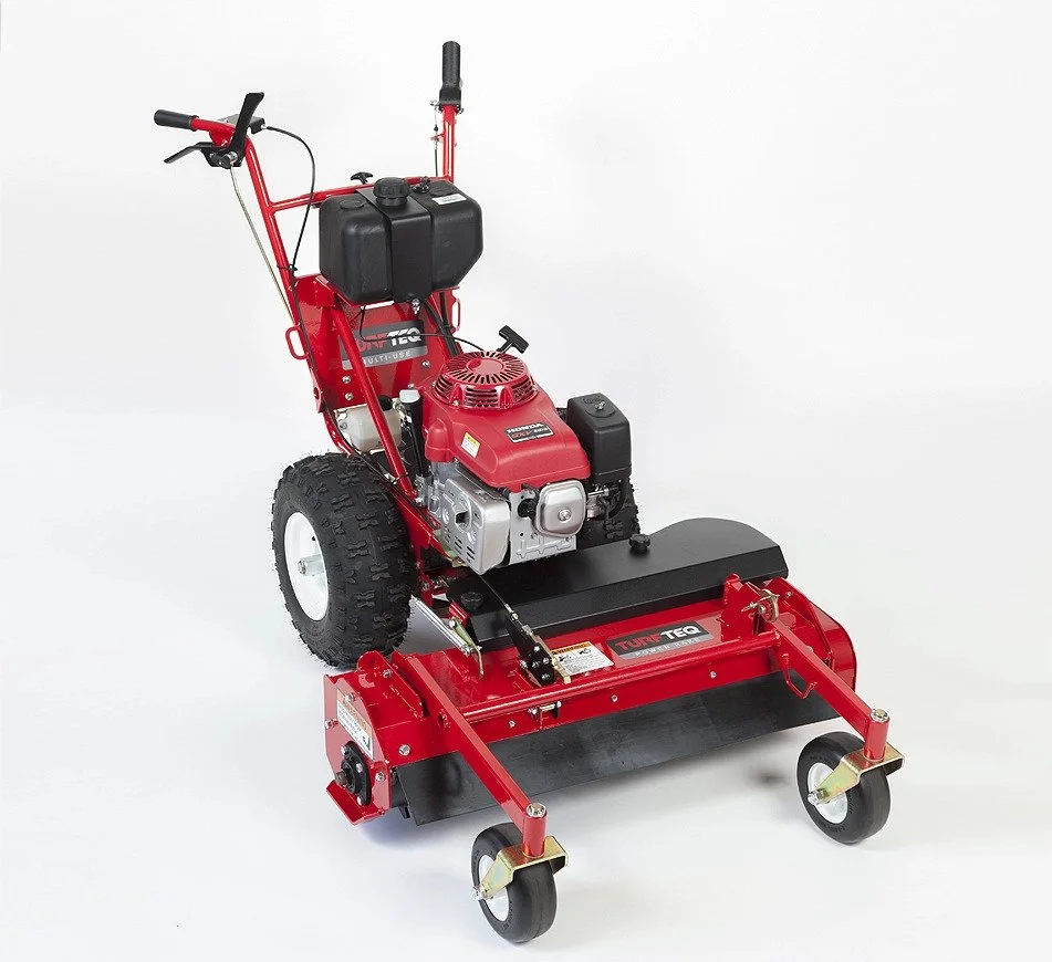 Red walk-behind brush cutter with a black engine, large tires, and caster wheels on a white background.