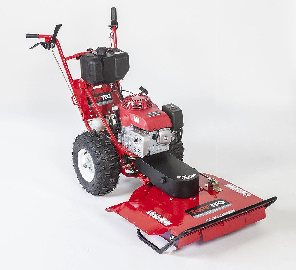 Red and black Turtetech brush cutter with engine, large tires, and a handle for pushing on a white background.