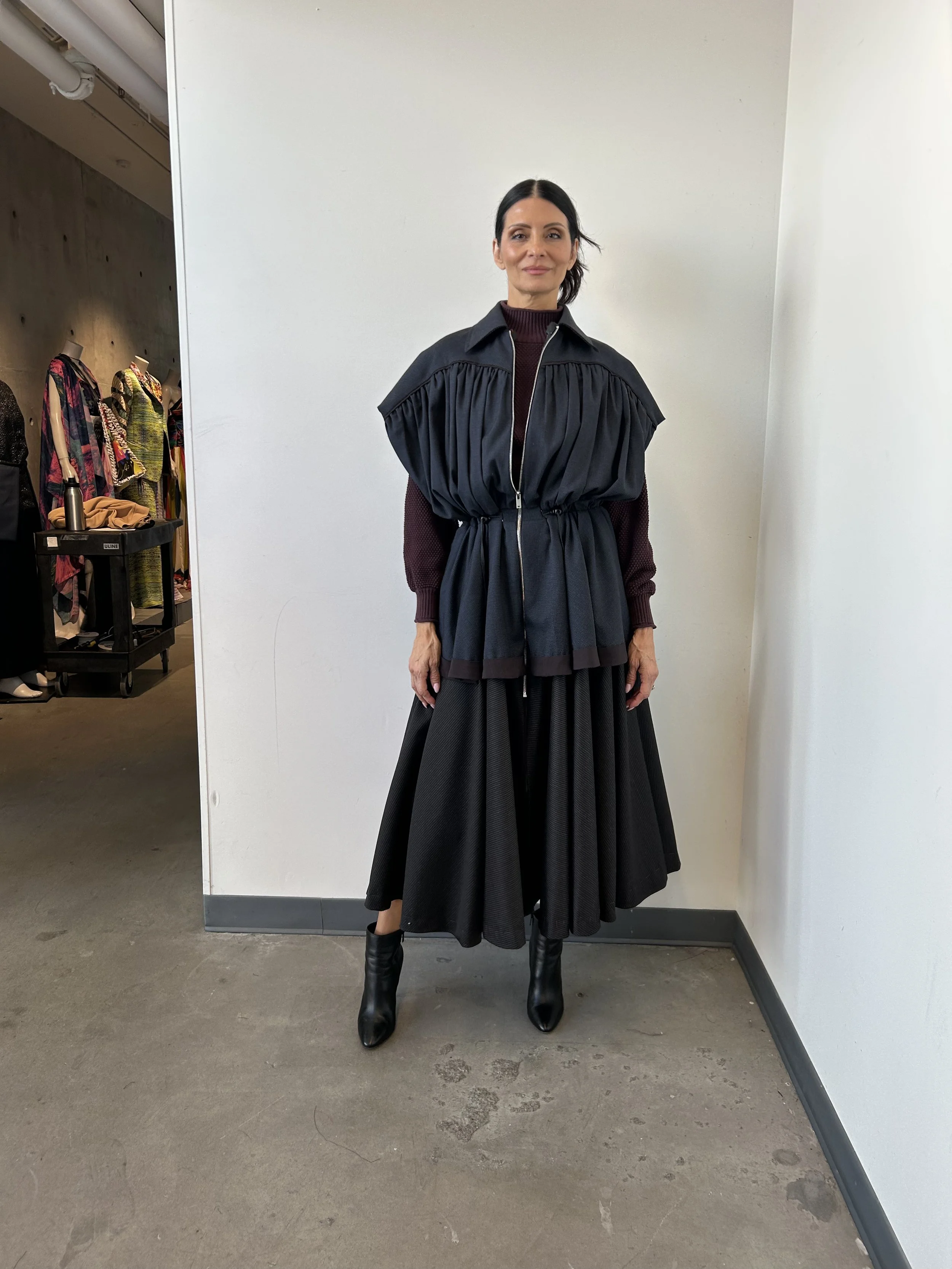Fit model wearing the first draft of the garment at the first fitting.