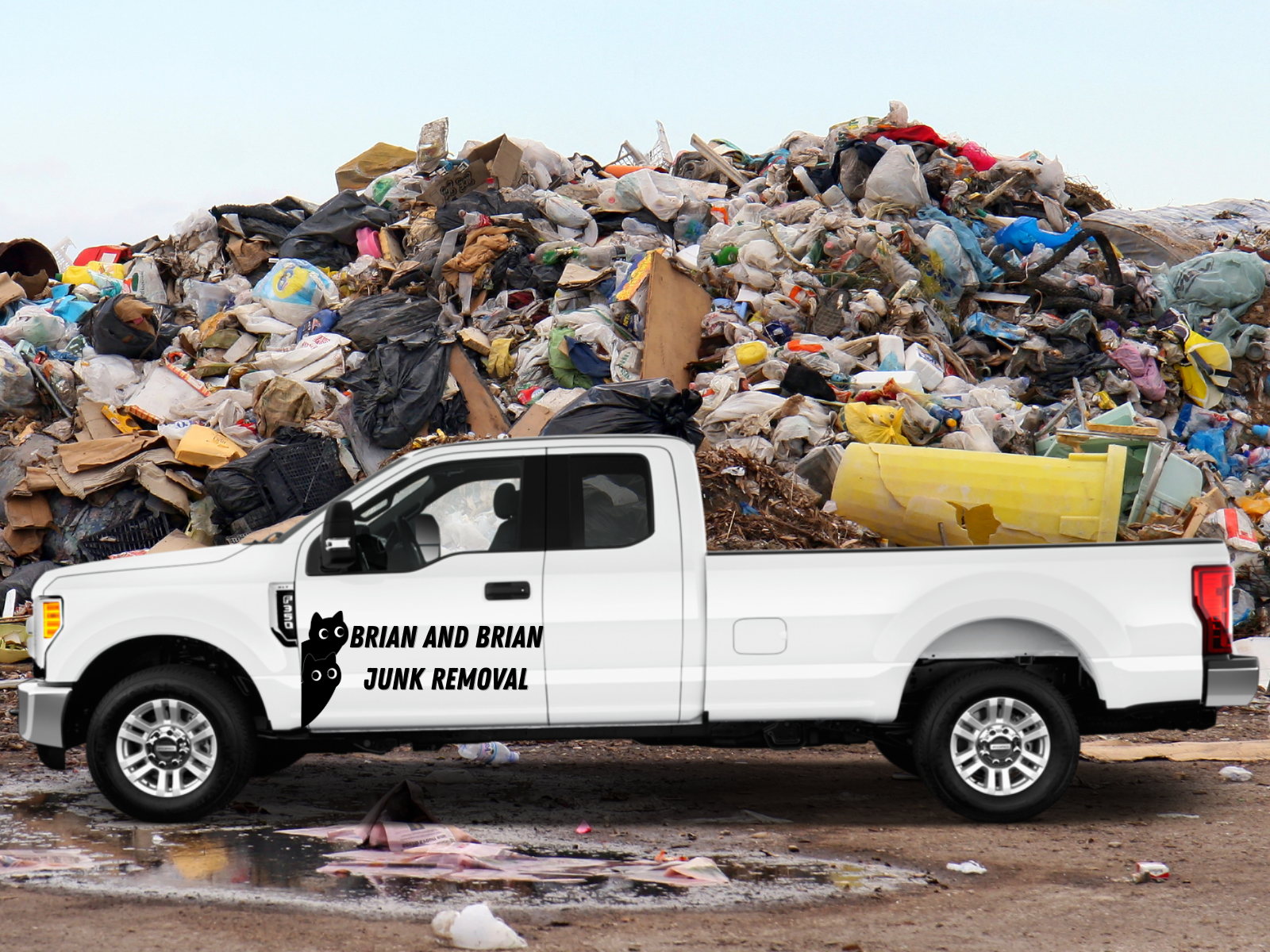 White pickup truck with branding for Brian and Brian Junk Removal parked in front of large garbage dump.