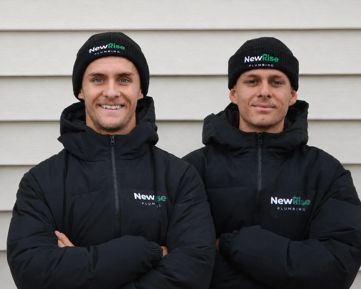 Jack and Cooper from NewRise Plumbing standing outside a residential property in Sydney.