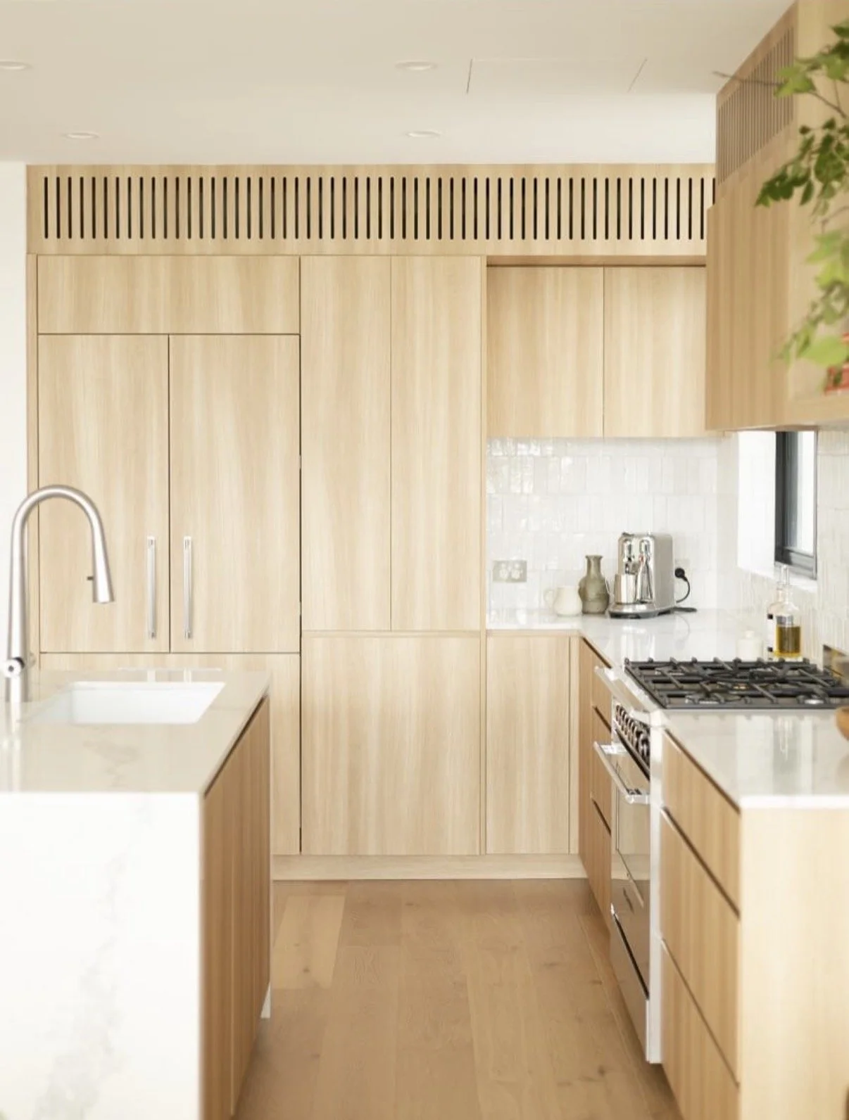 Coastal kitchen renovation in Coogee with timber cabinetry, stone benchtops and integrated appliances
