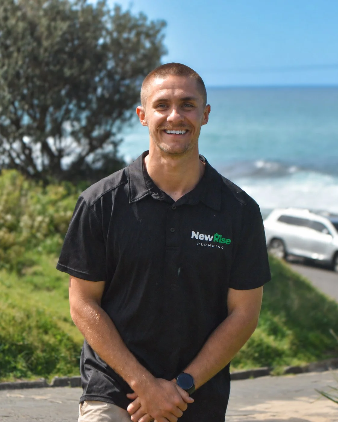 Jack, founder of NewRise Plumbing, wearing his NewRise uniform outdoors in Sydney
