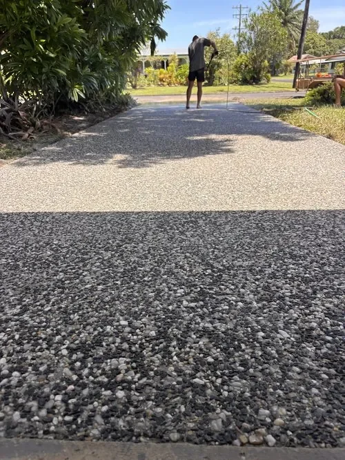 Exposed aggregate concrete driveway with decorative stone finish in Cairns.