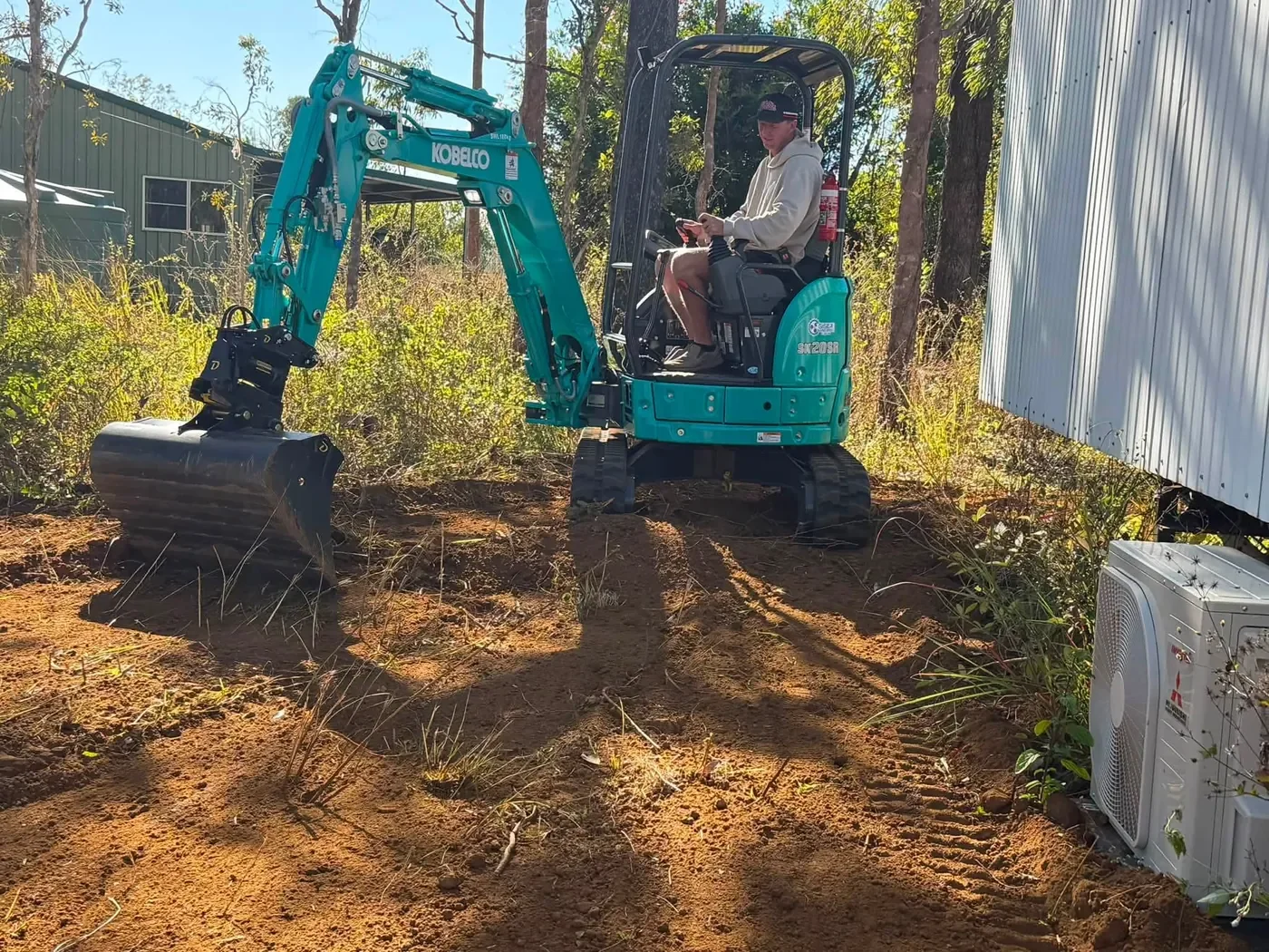 Mini excavator operator completing earthmoving and site preparation on the Atherton Tablelands.