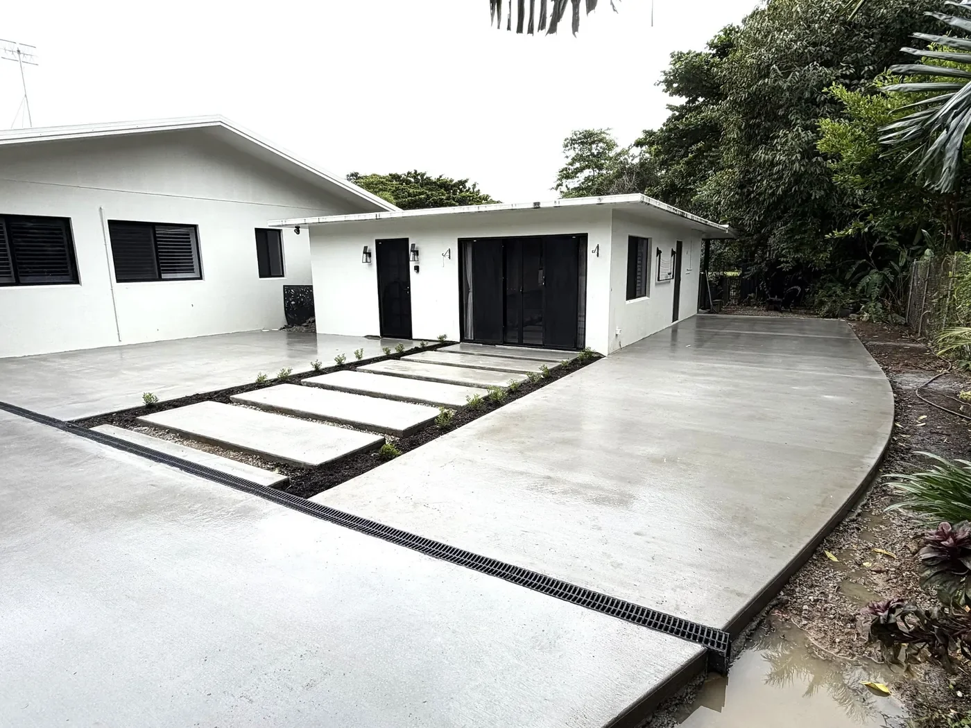 New concrete driveway and entrance surrounding a residential property in Cairns.