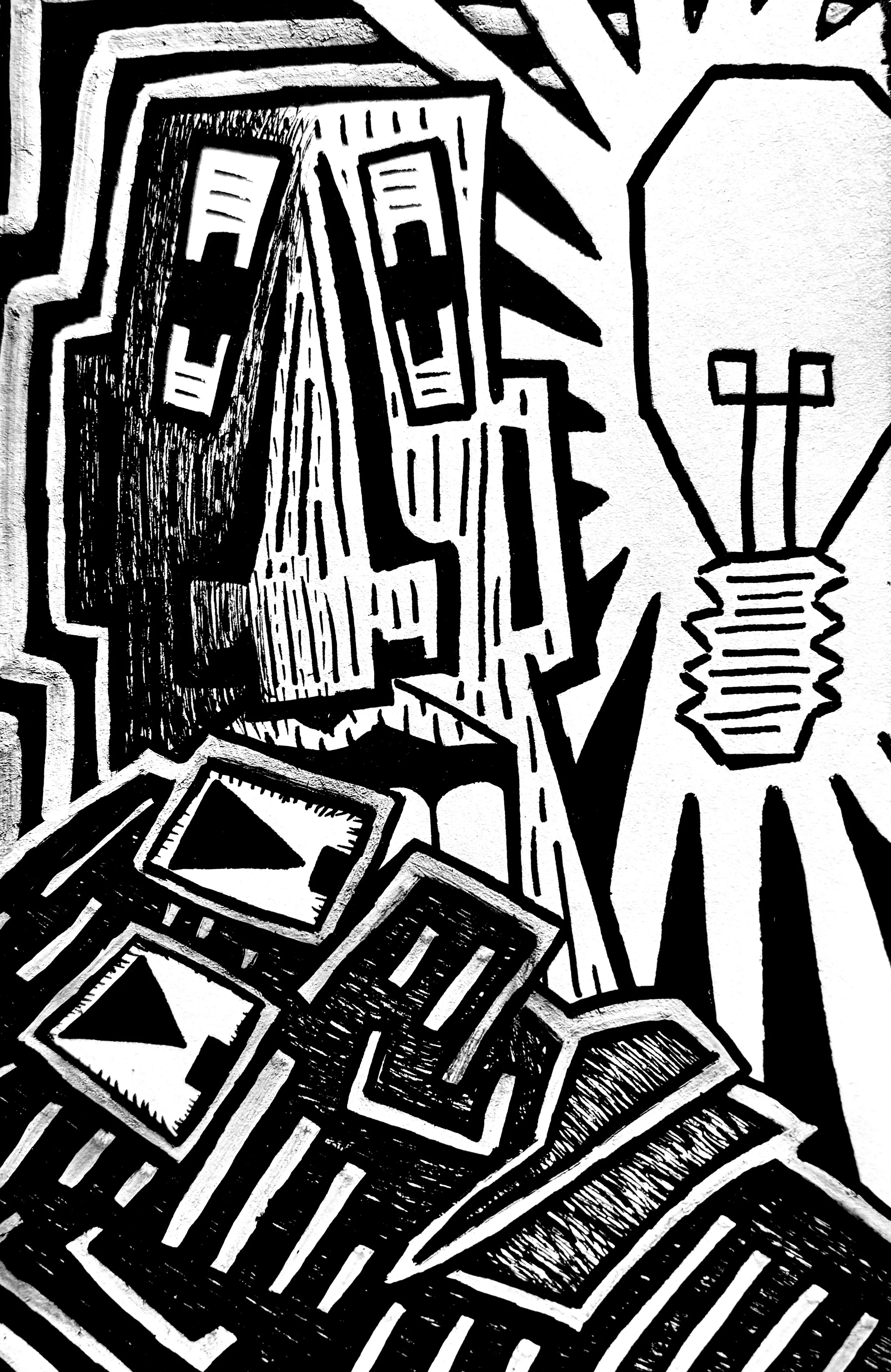 Black and white abstract artwork with geometric shapes and bold lines creating faces.