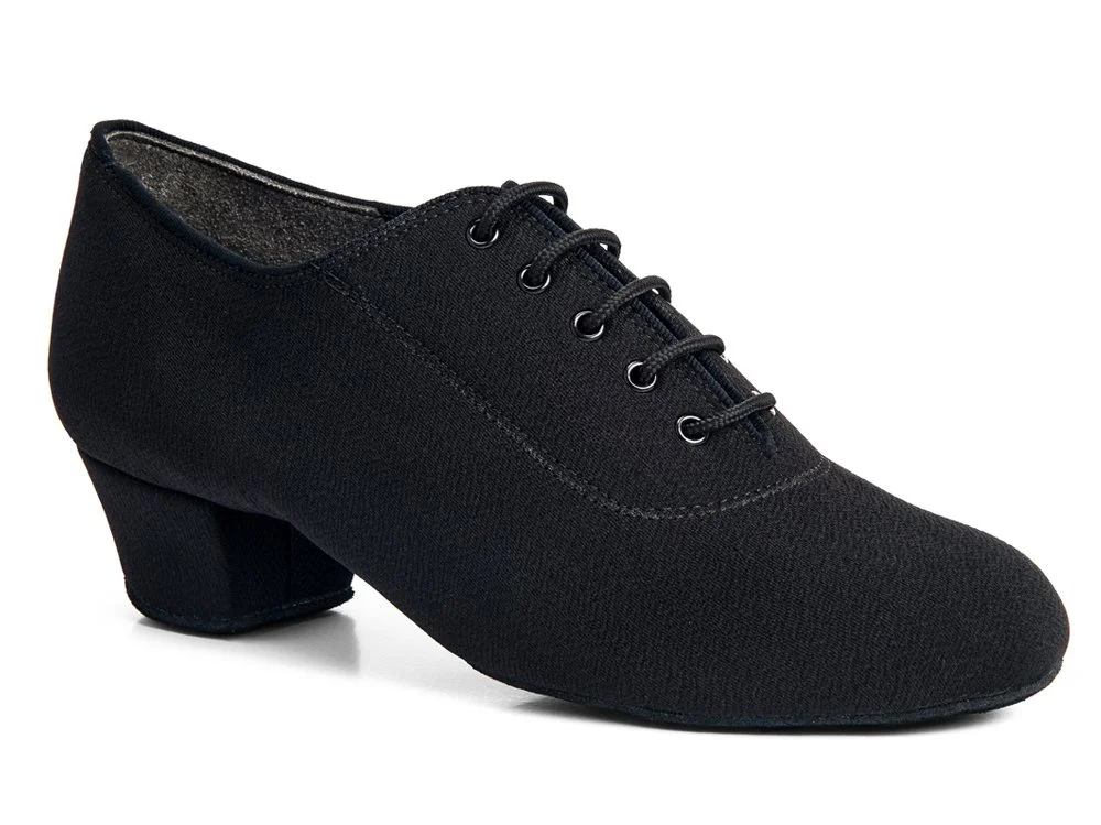 Black dance shoe with a low heel, lace-up front, and textured fabric appearance.