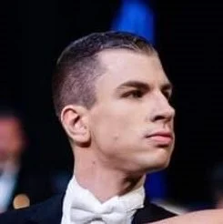 Portrait of a man with short dark hair dressed in a tuxedo and bow tie