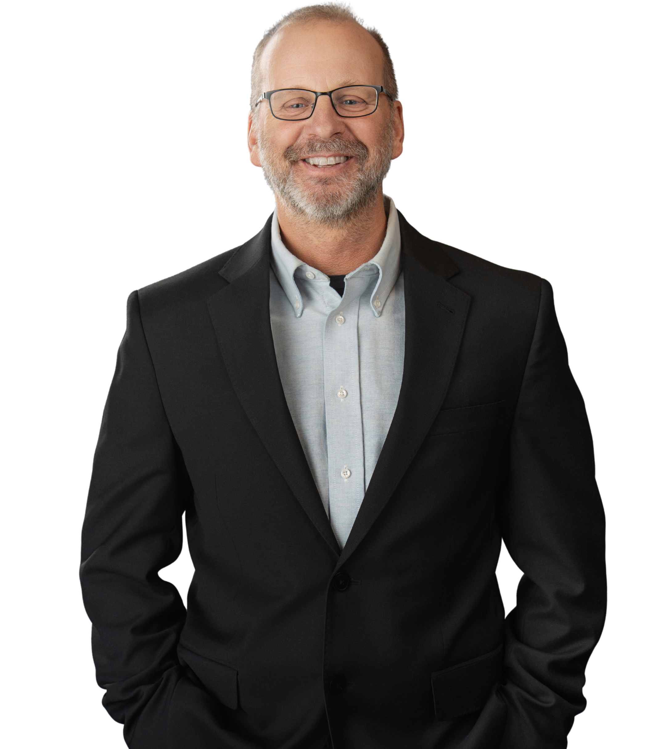 A smiling middle-aged man with glasses, a gray beard, wearing a black suit jacket and a light blue collared shirt.