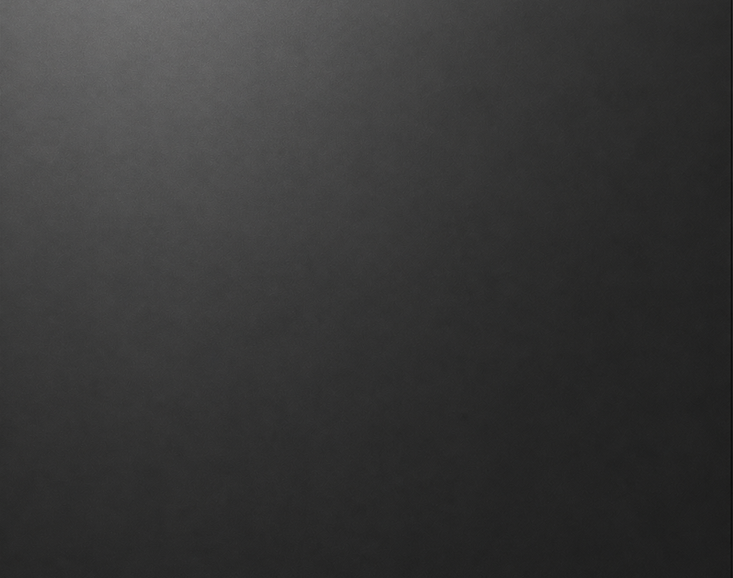 Close-up of a dark gray textured surface, possibly a matte material or fabric.