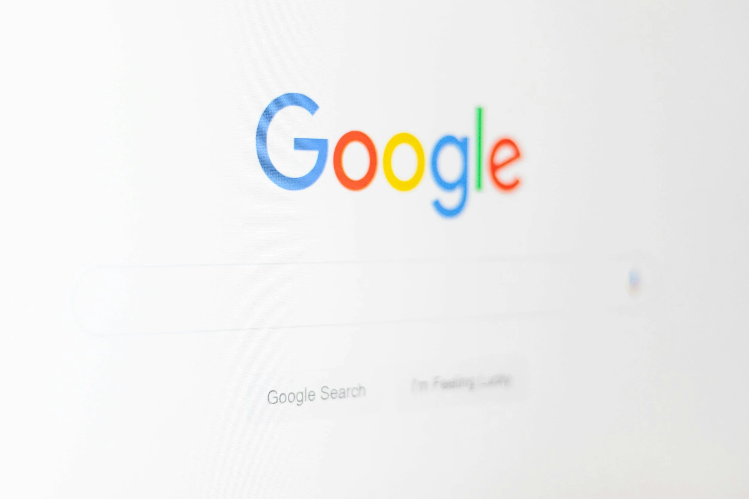Computer screen displaying the Google search homepage with the Google logo and search options.