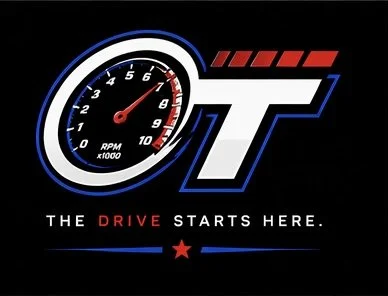 A logo featuring a tachometer gauge with RPM numbers, the stylized letters 'T' with red stripes, and the text 'The drive starts here' with a red star below.