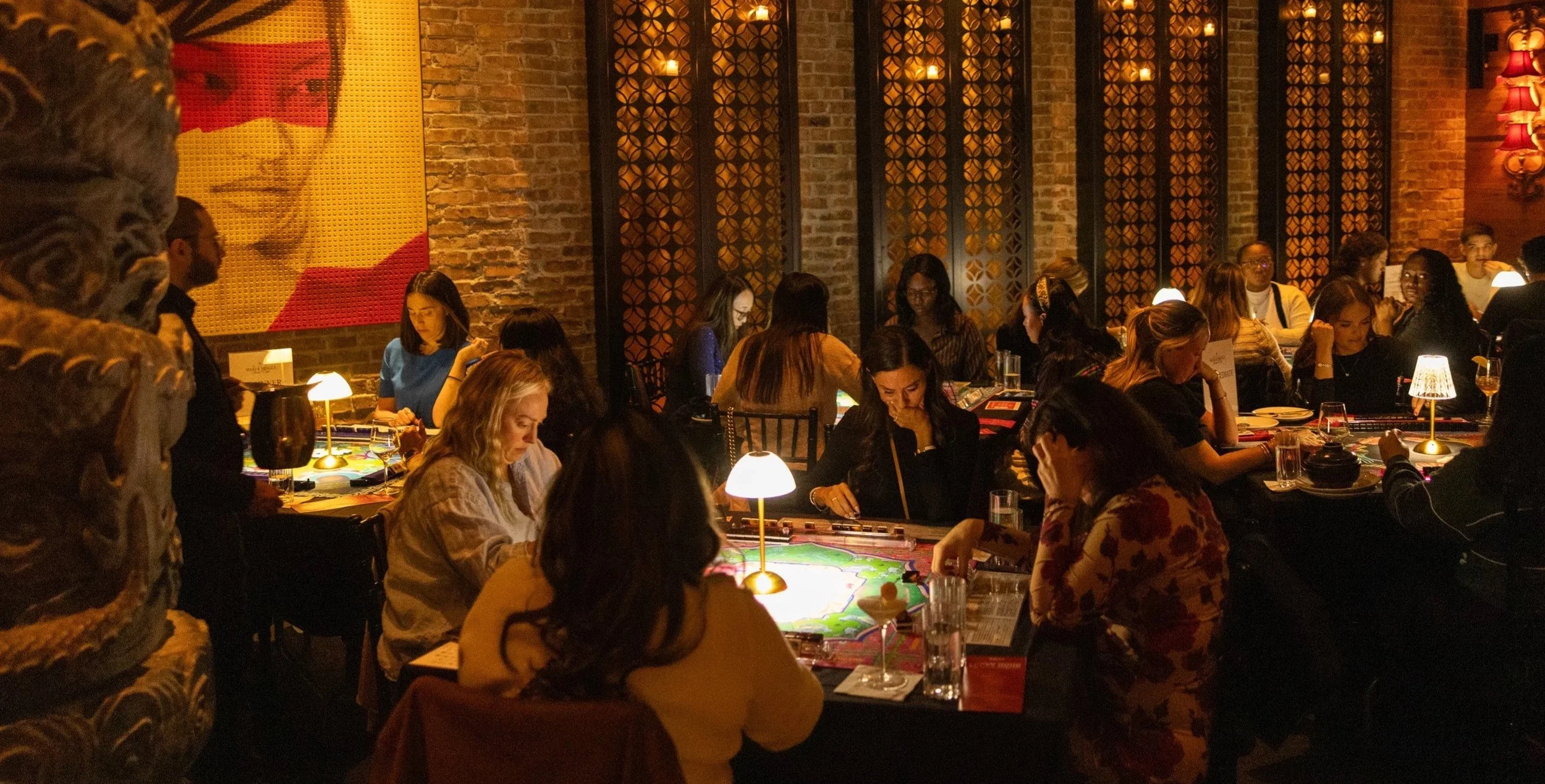 Mahjong players gathering around tables at a Mahj & Mingle Social Club event at TAO Chicago.