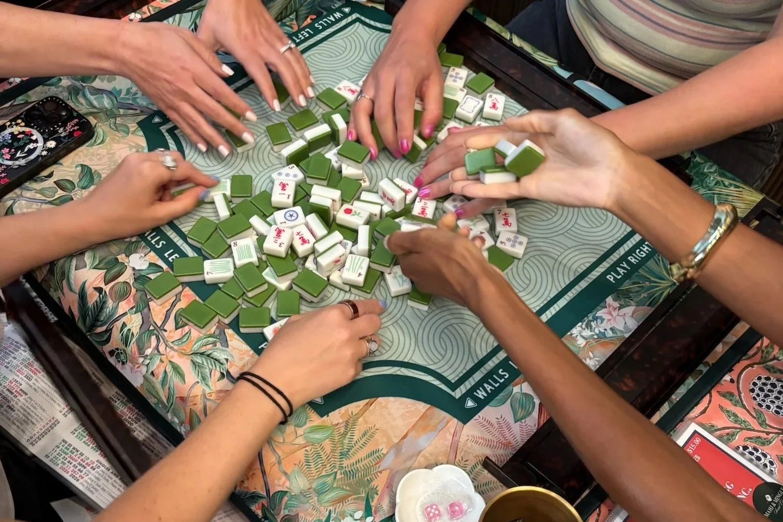 Players practicing American Mahjong with guided support at a Mahj & Mingle event in Chicago
