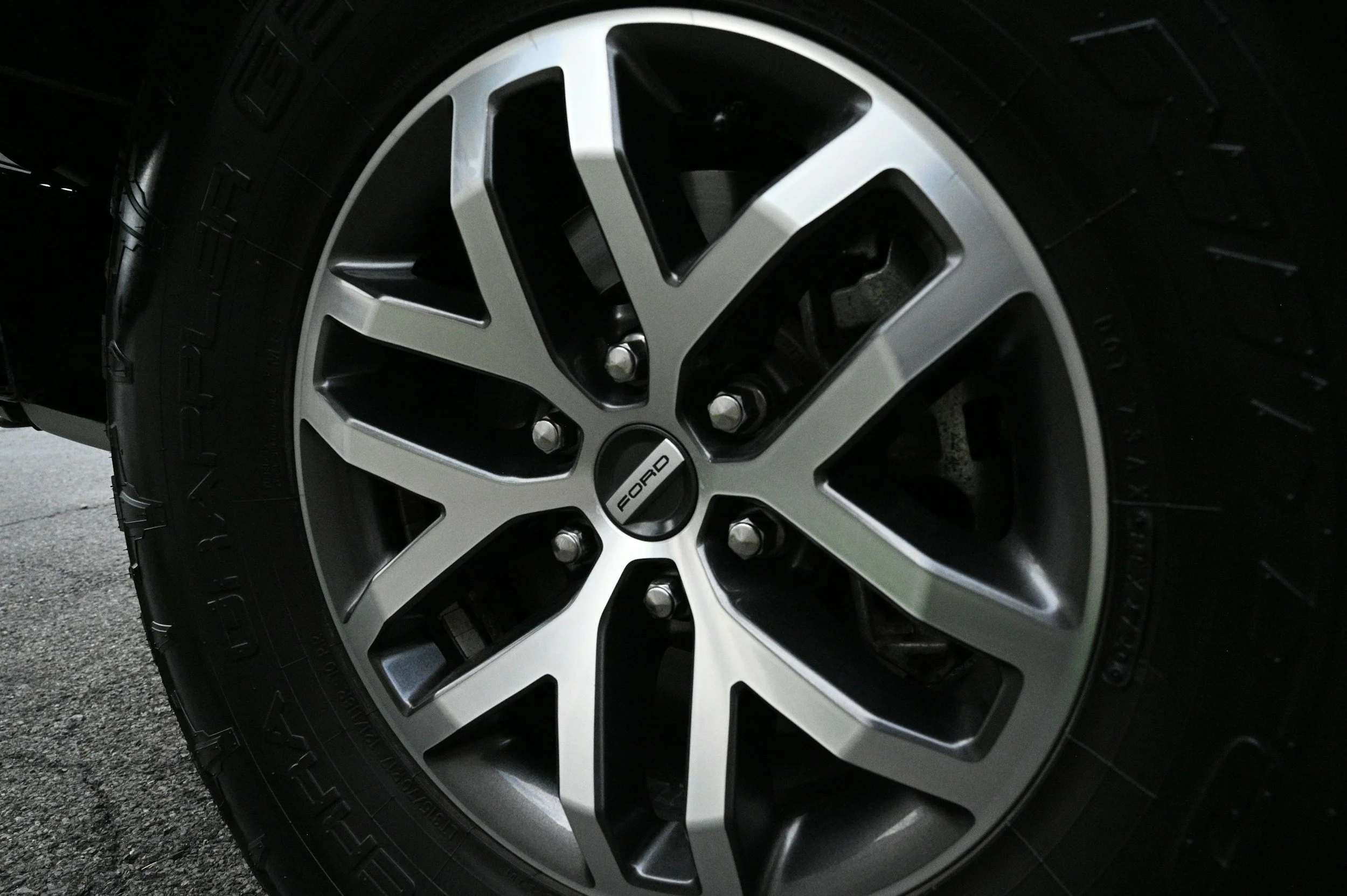 Close-up of a car tire and alloy wheel with Ford logo