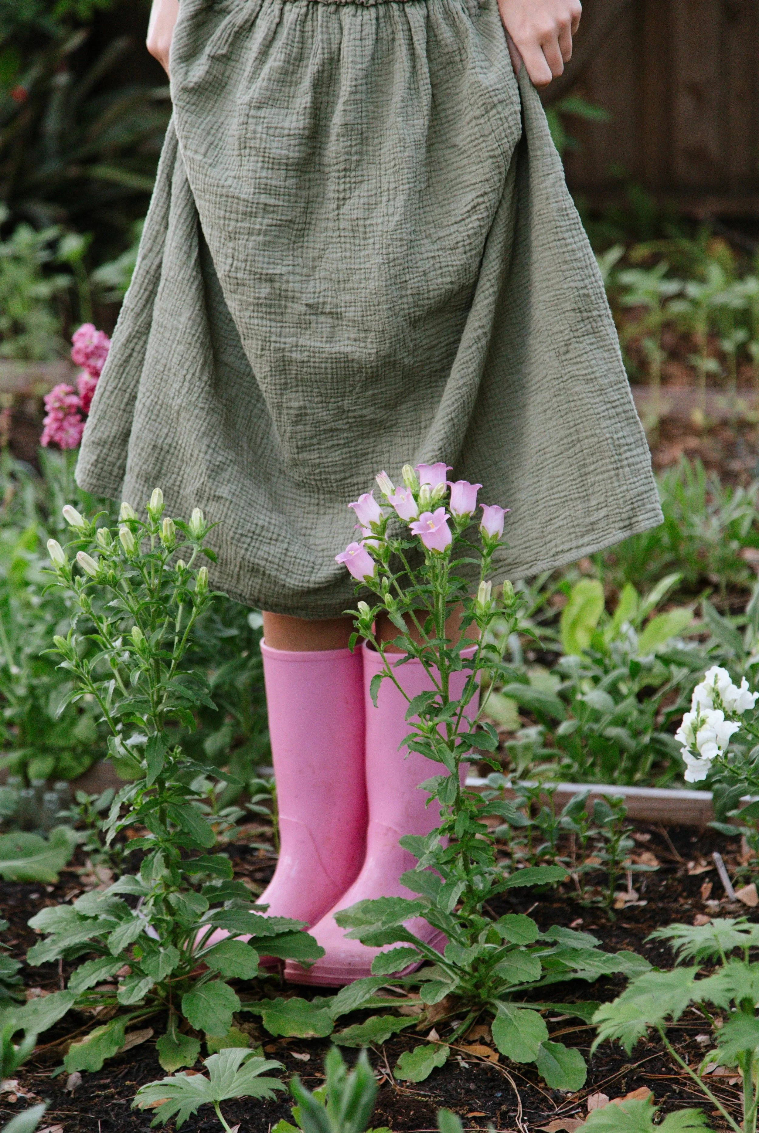 Ellen, the owner and lead designer standing in the garden 