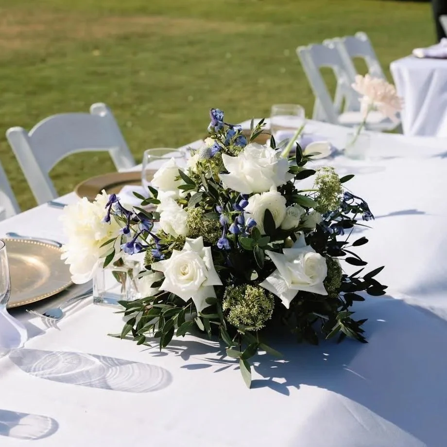 A blue, white, and green floral centerpiece for a wedding