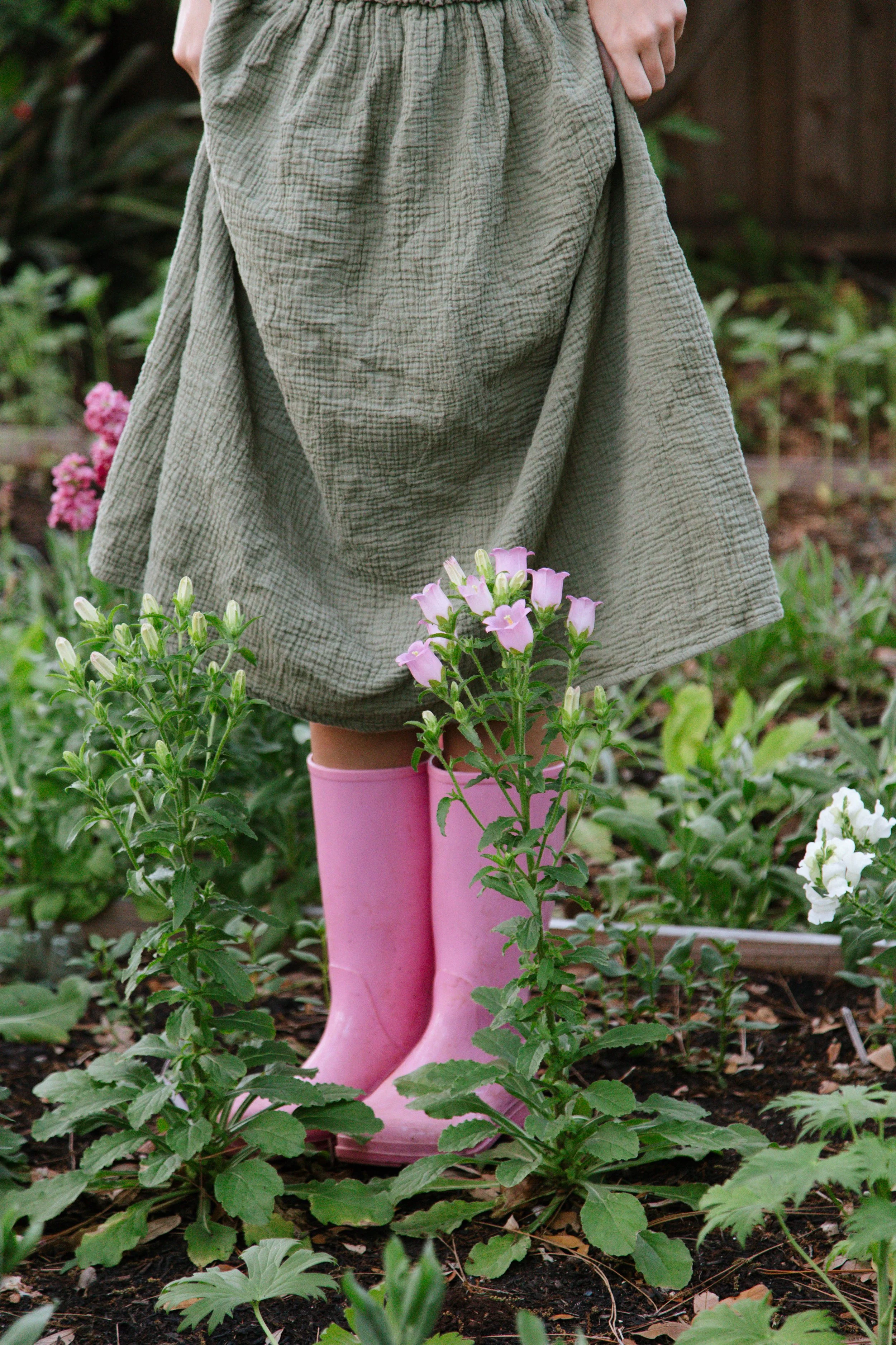 Standing in the garden with pink rain boots