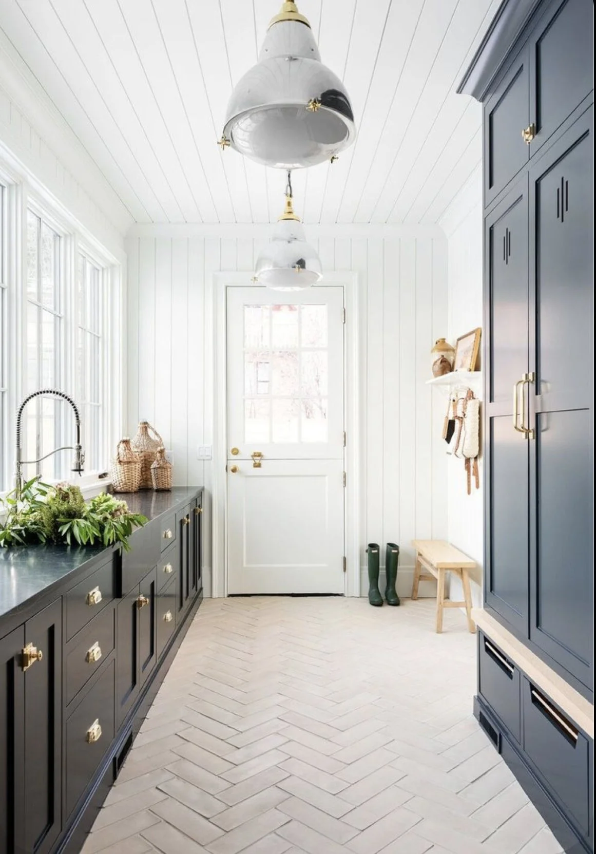 Castle Pines kitchen with white shiplap, navy cabinetry, and herringbone tile floor.