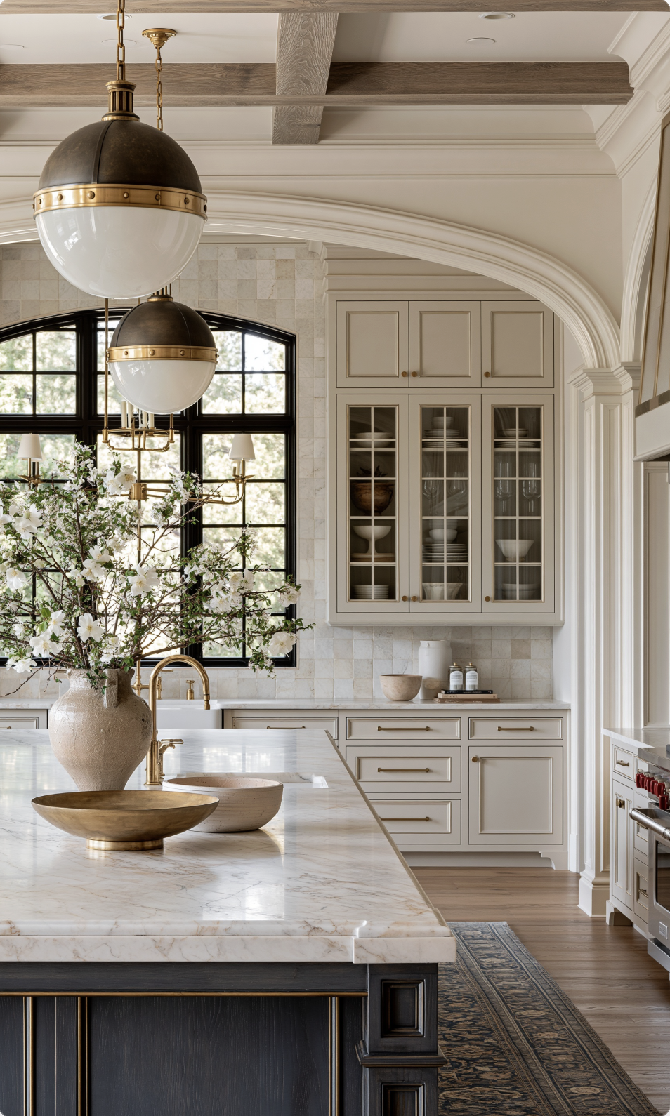 Kitchen renovation with marble island and black-framed windows by Indigo Day Designs in Castle Rock, CO