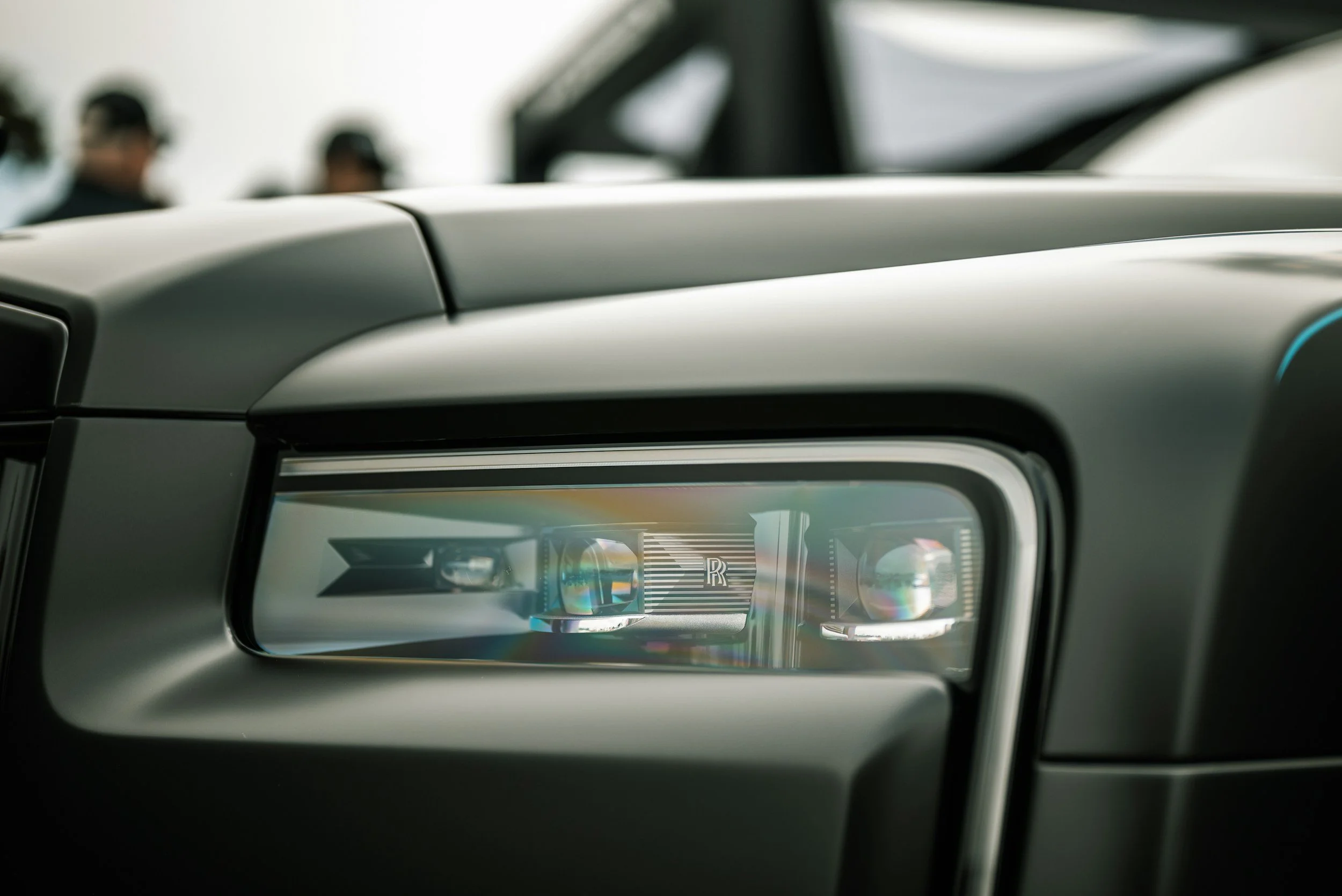 Rolls-Royce headlight close-up after detailing with high-gloss finish and restored clarity