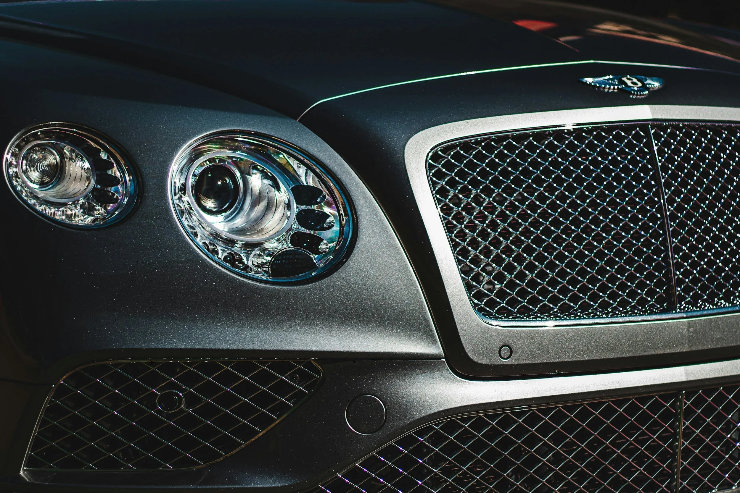 Bentley front end with polished grille and glossy finish after professional automotive detailing