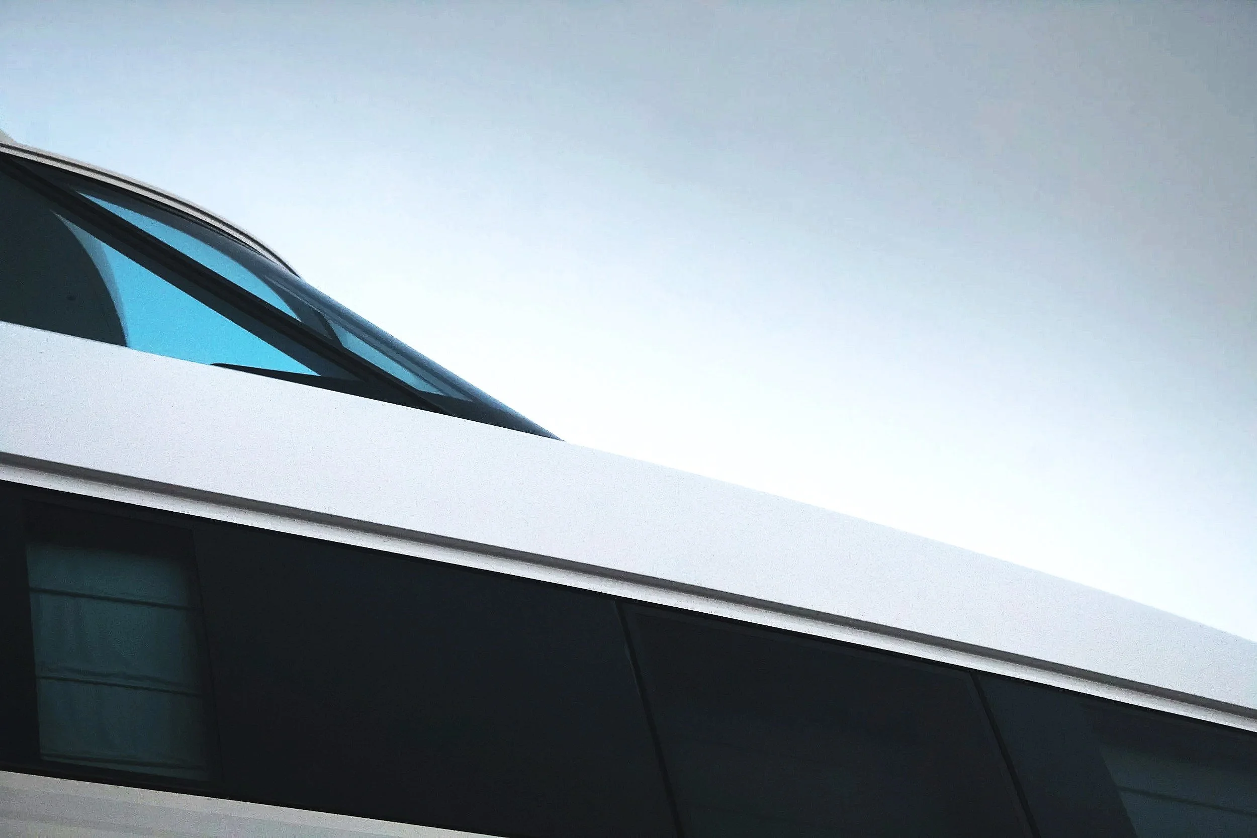 Side of luxury yacht with polished hull and high-gloss finish after professional marine detailing