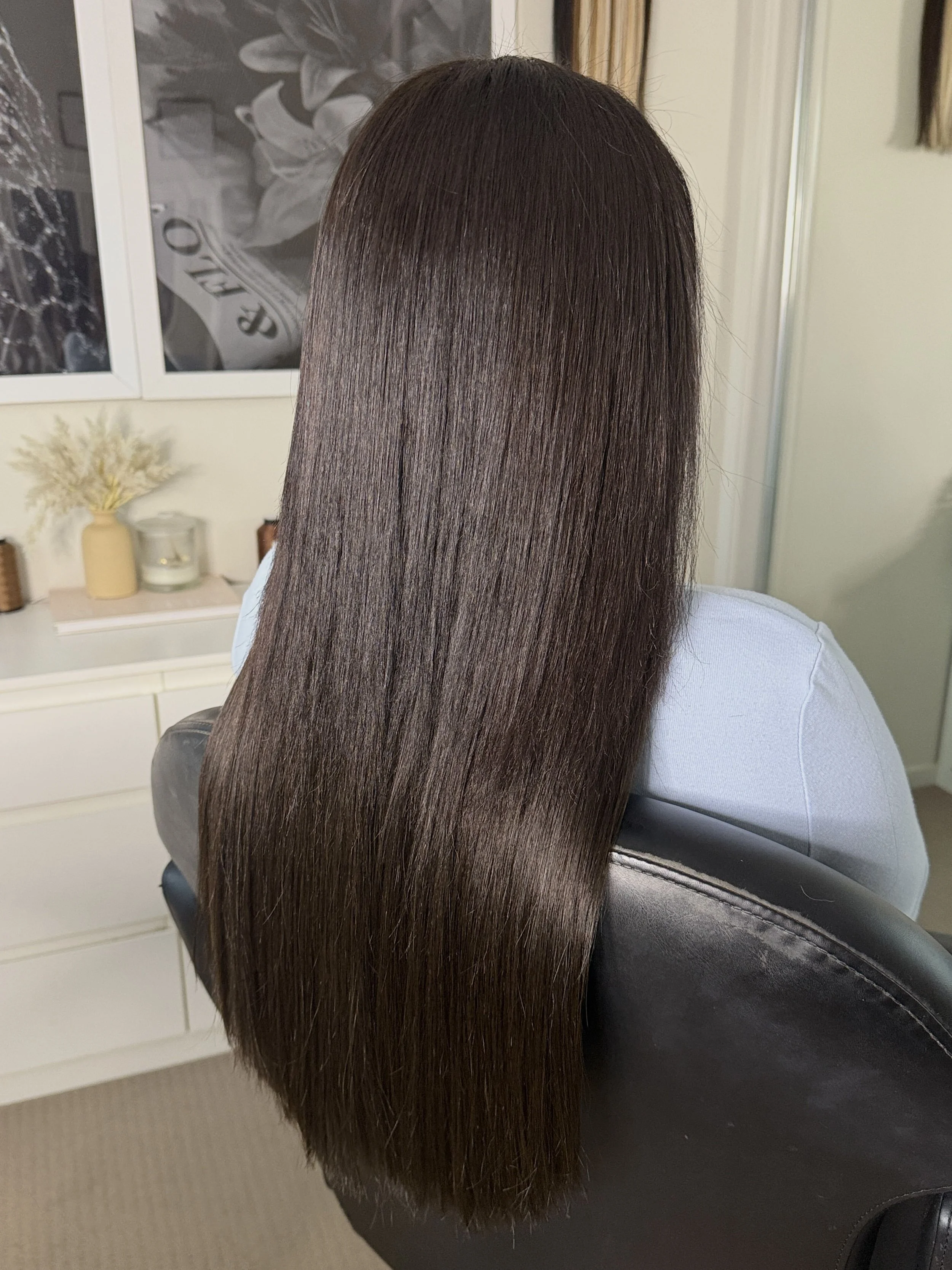 Long, straight dark brown extensions, seamlessly blended for a flawless, naturally elevated finish.