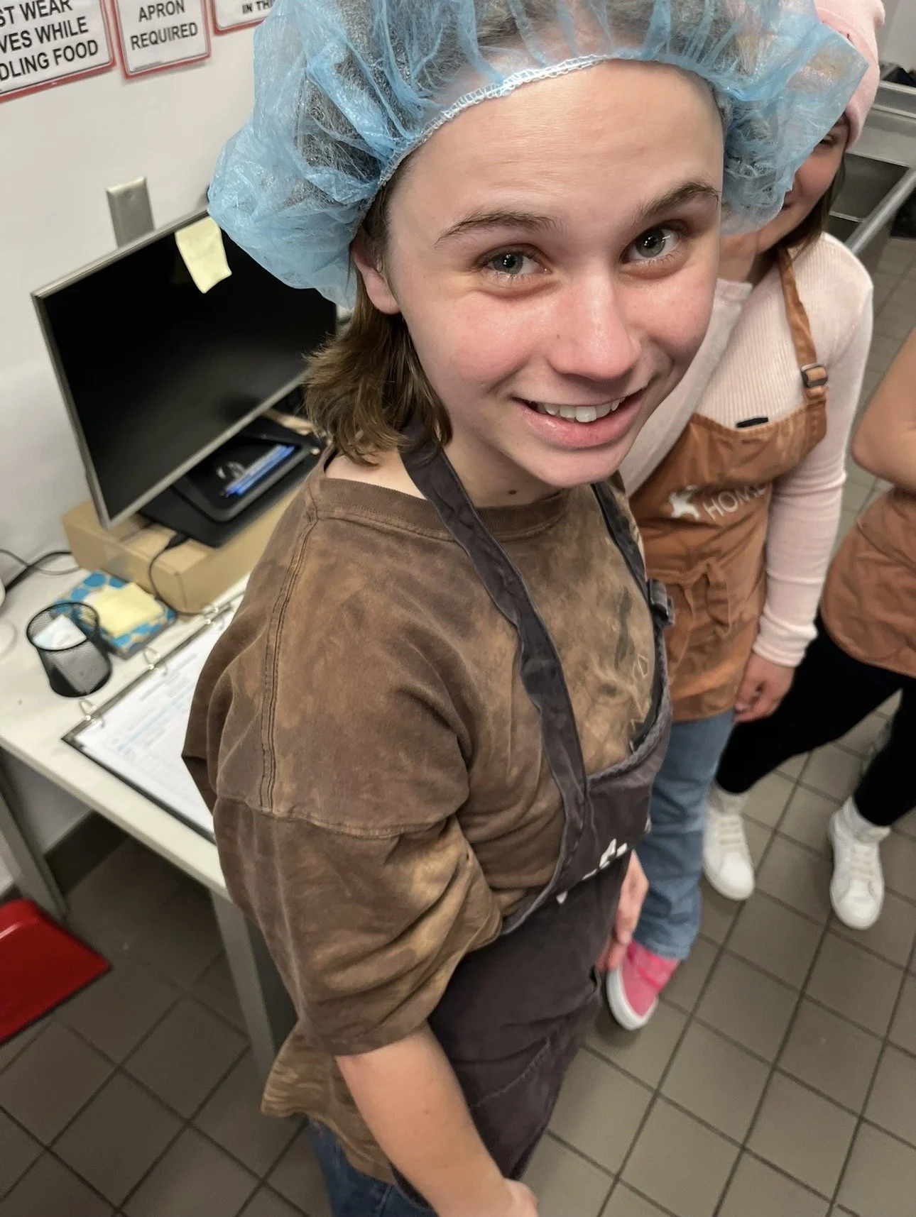 Julia Castellano in a kitchen prepping food for the homeless on an outing 