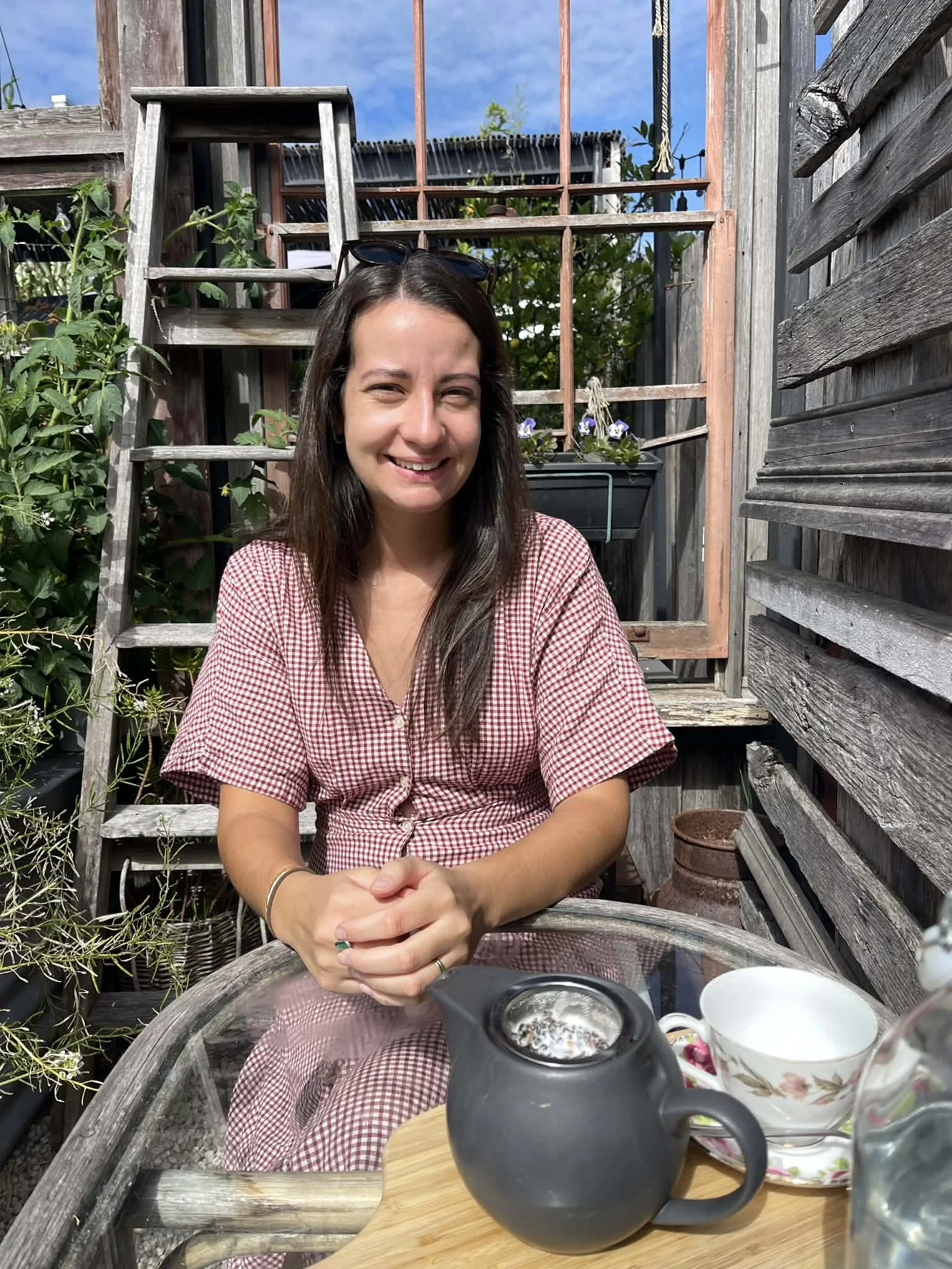 Justine, the practitioner enjoying a cup of tea outdoors.