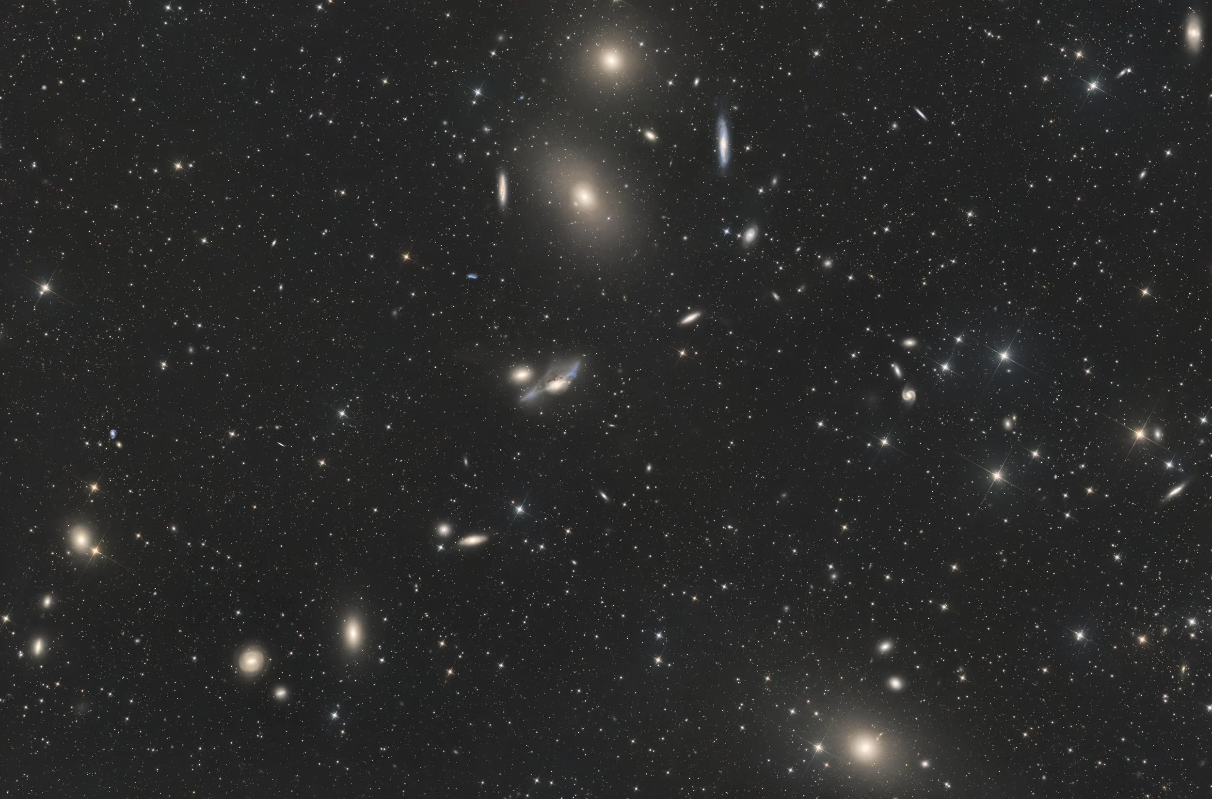 A detailed image of numerous stars and galaxies in deep space.