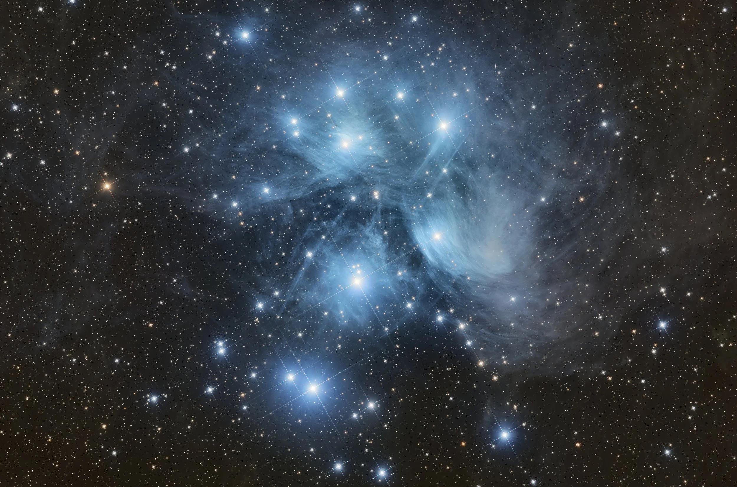 A stunning, detailed view of outer space with countless stars, bright cosmic dust clouds, and glowing nebulae.