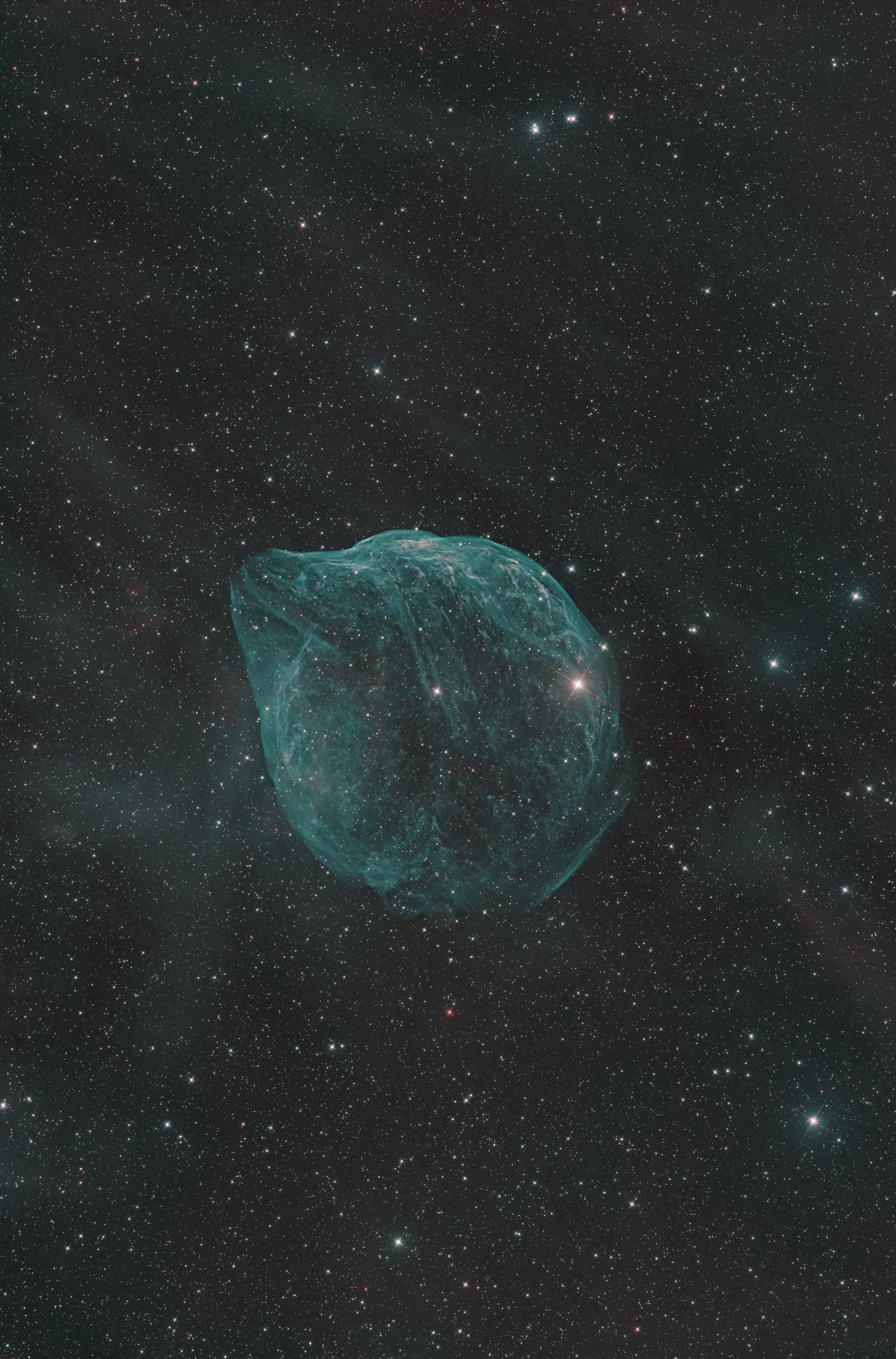 A composite image of the universe showing numerous stars and a nebula with a bright, glowing, cloud-like structure in space.