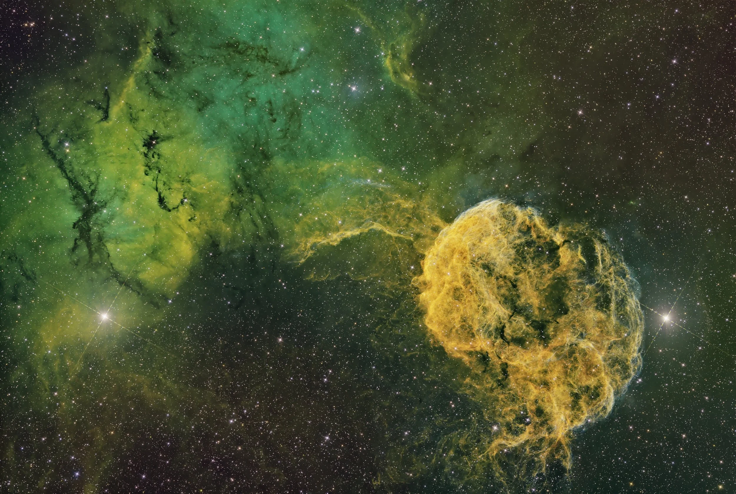 A vibrant image of outer space featuring a green nebula with swirling clouds of gas and dust, scattered stars, and bright yellow regions.