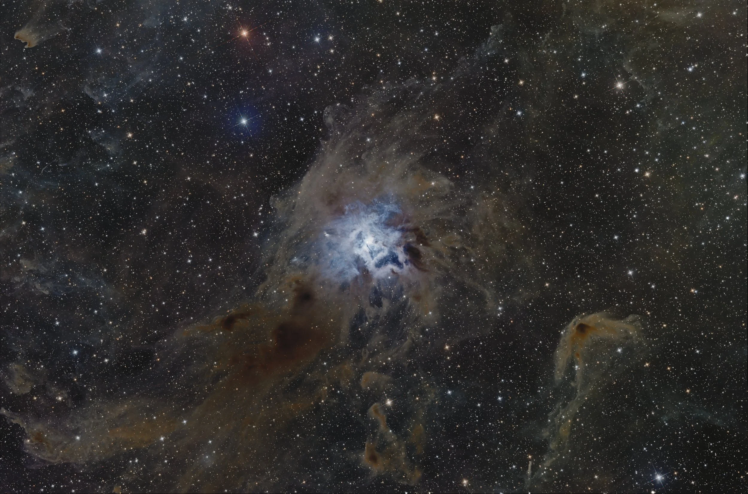 Deep space image showing numerous stars, nebulae, and cosmic dust clouds.