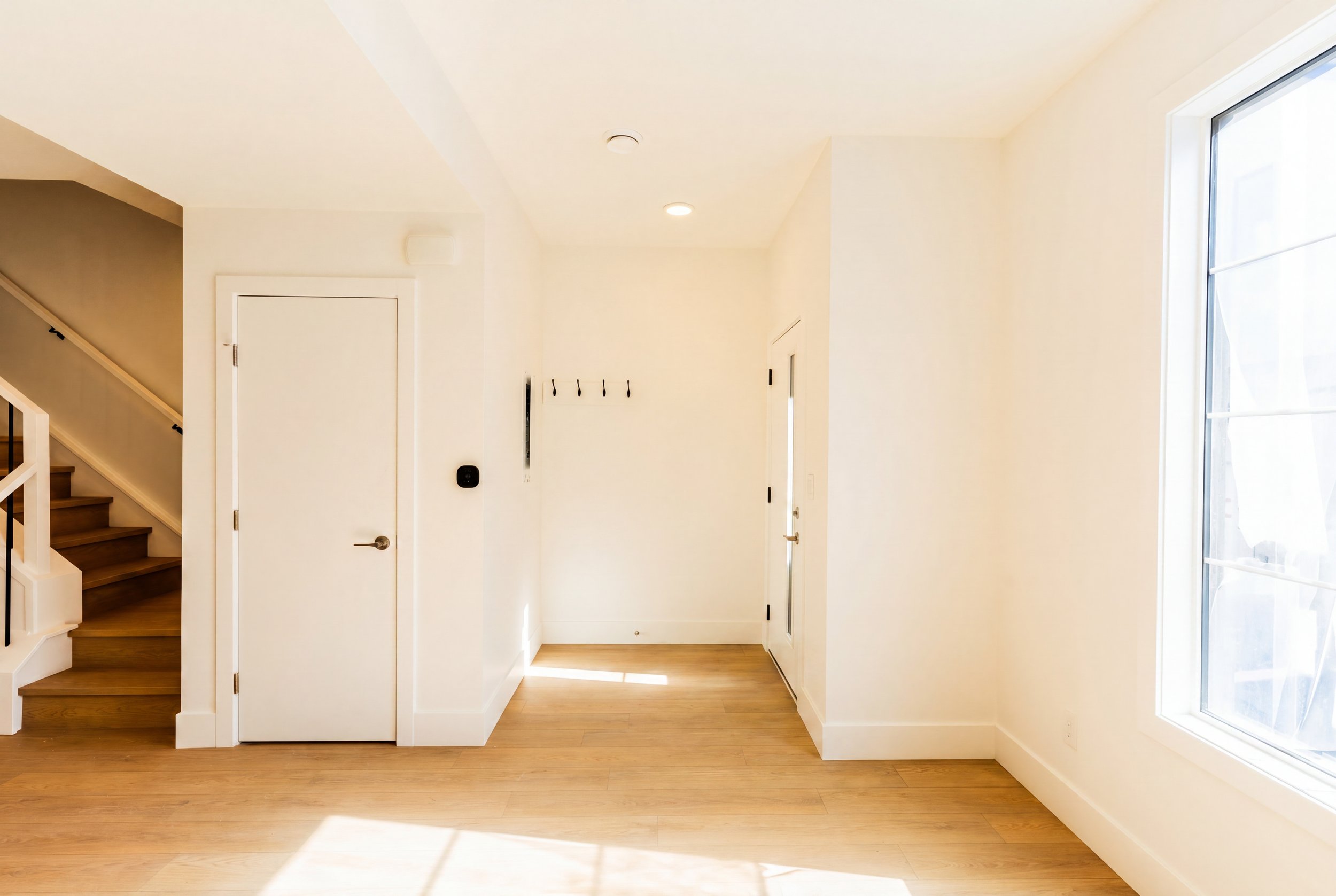 Unit 202 Uptown 17th Calgary 3-bed townhouse entrance hallway with staircase and interior door - available at Suite Getaways