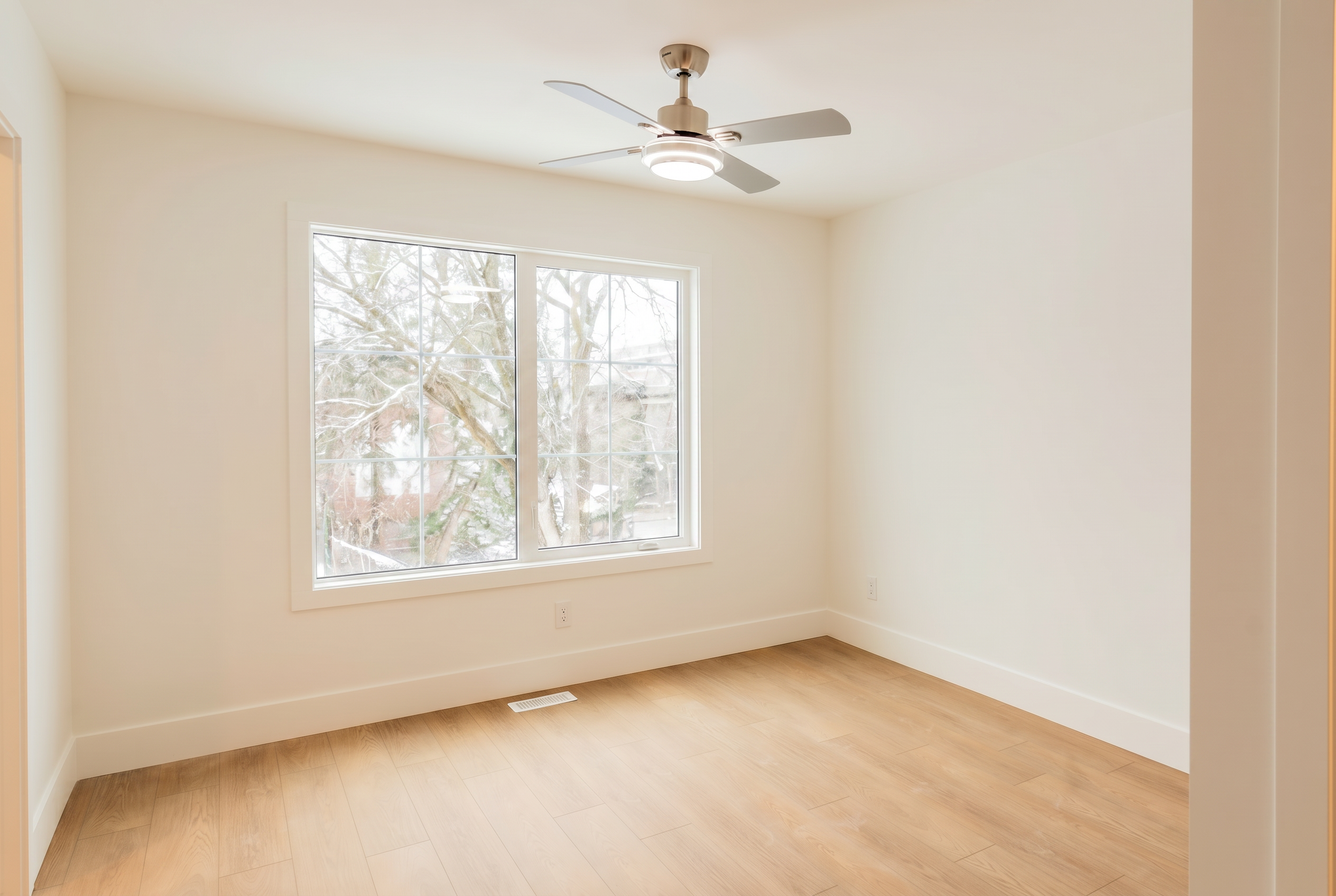 Bright bedroom with ceiling fan and large windows in Unit 104 Uptown 17th Calgary 3-bedroom townhouse rental near 17th Ave SW by Suite Getaways