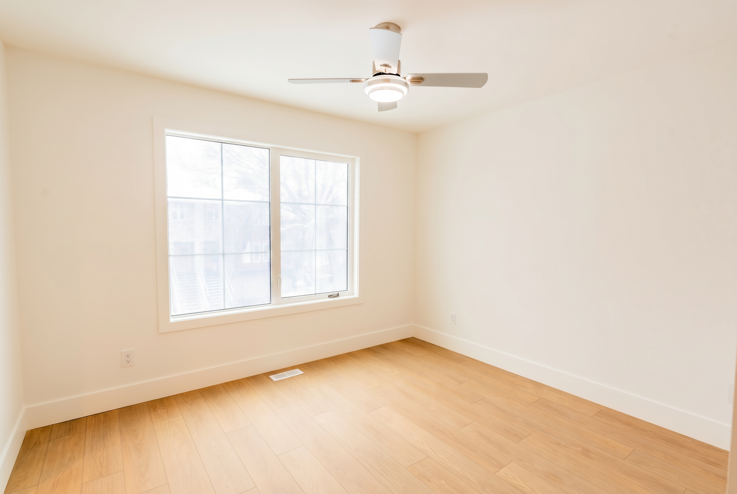 Bright bedroom with ceiling fan and large windows in Unit 103 Uptown 17th Calgary 3-bedroom townhouse rental near 17th Ave SW by Suite Getaways