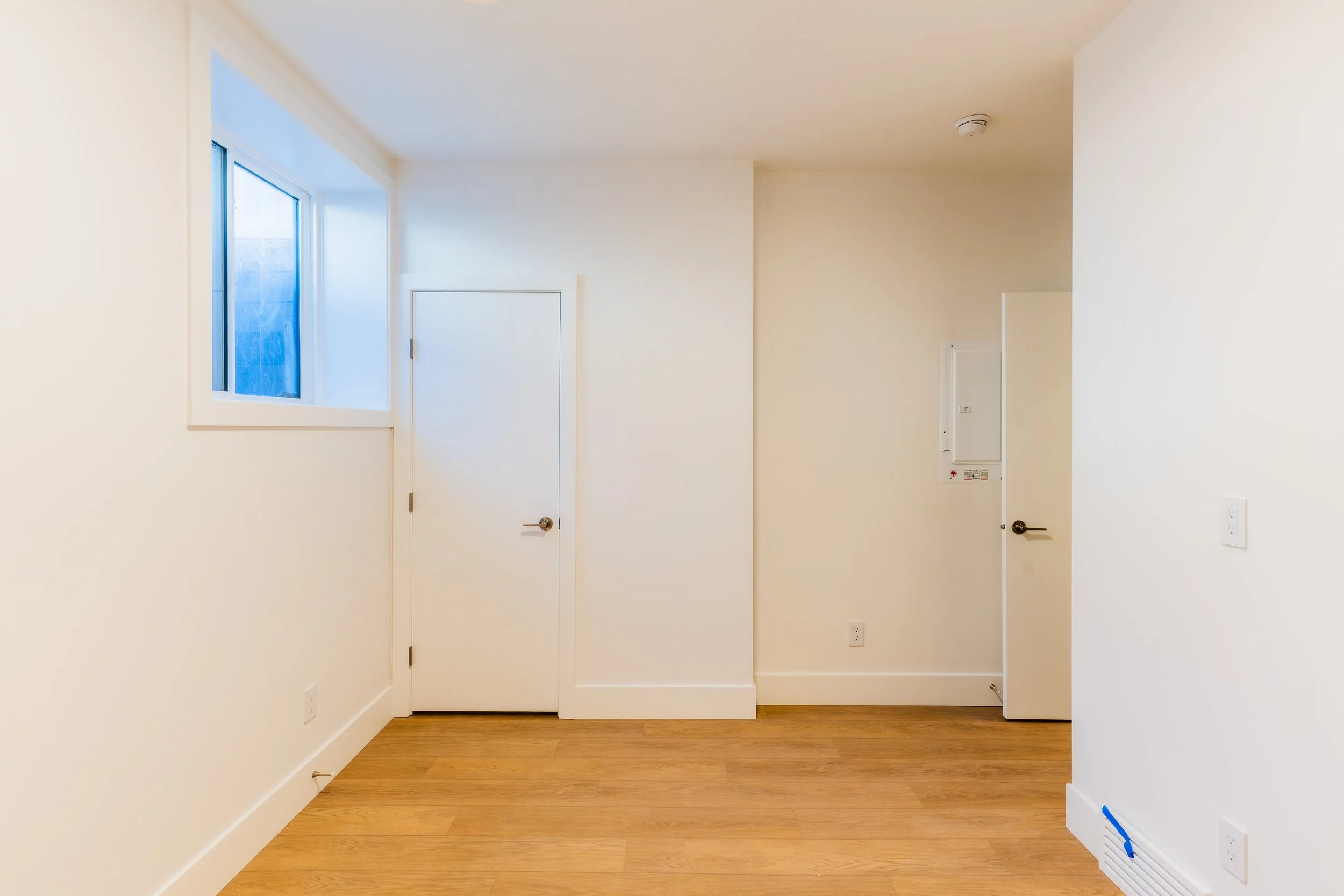 Private entrance hallway with two doors in Unit 201R Uptown 17th Calgary 1-bedroom lower suite rental near 17th Ave SW by Suite Getaways