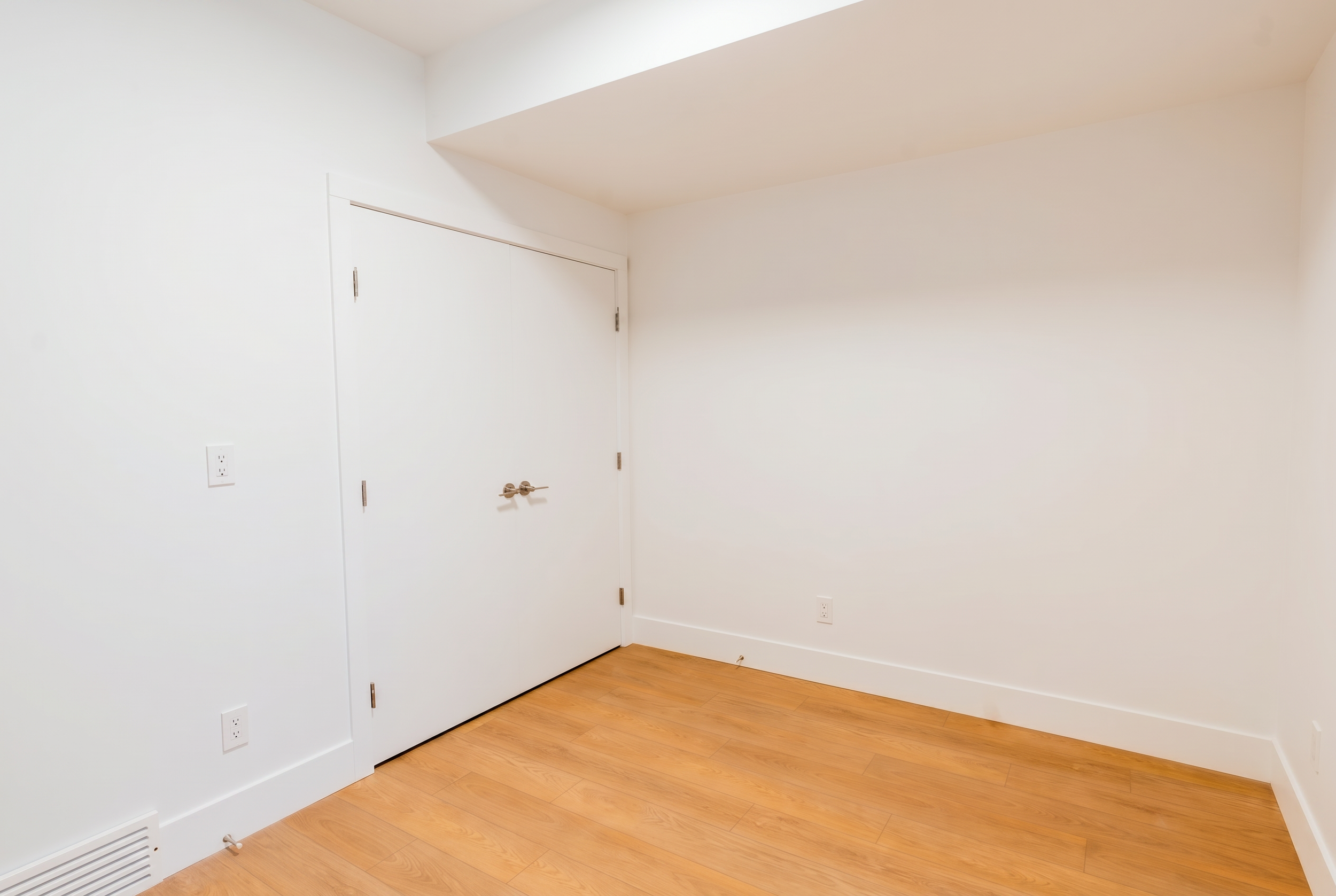 Private entryway with closet and door in Unit 101R Uptown 17th Calgary 1-bedroom lower suite rental near 17th Ave SW by Suite Getaways