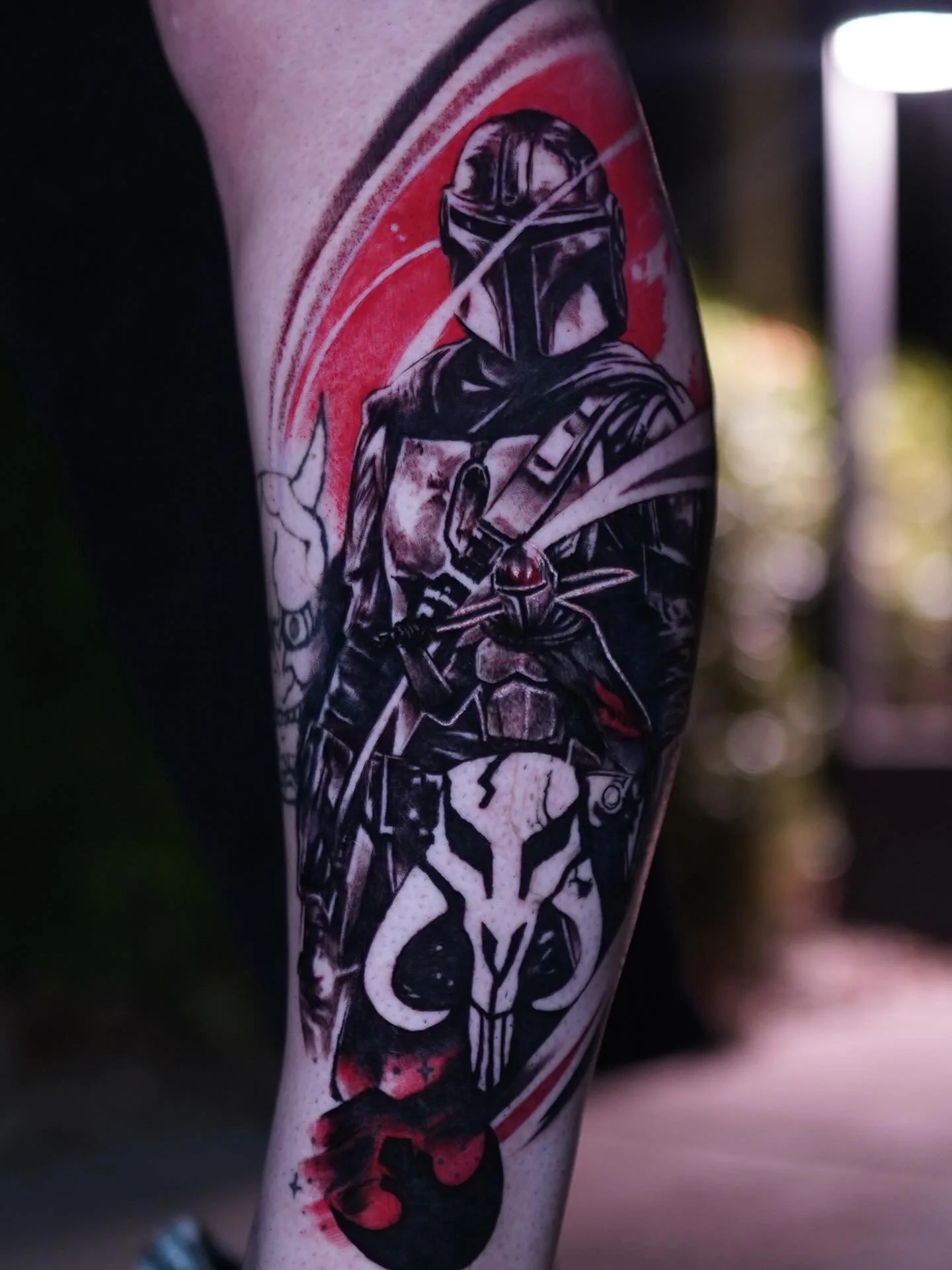 Close-up of a tattoo of Darth Vader from Star Wars on a person's arm.