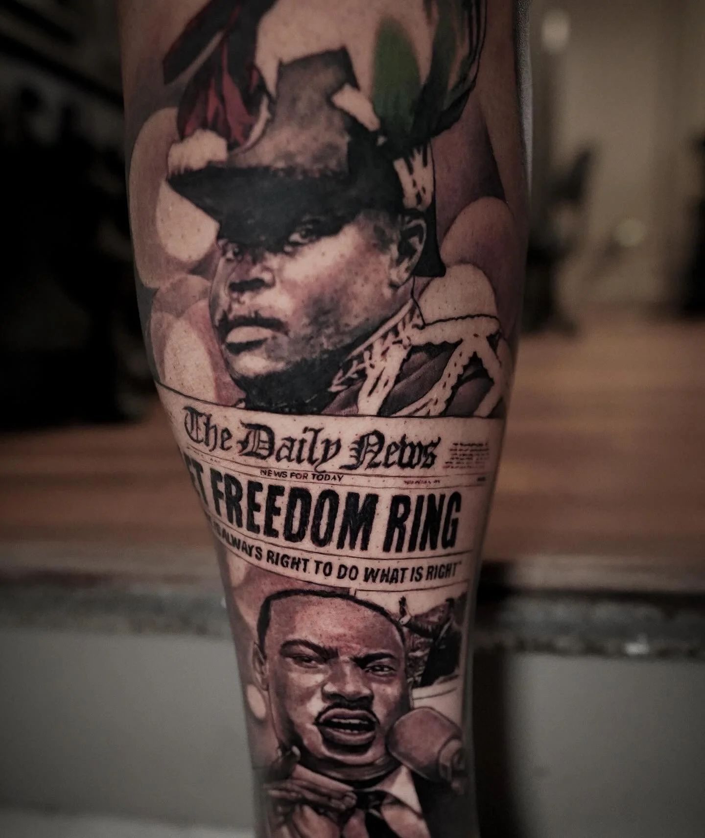 Tattoo of a vintage newspaper headline titled 'The Daily News' with an image of a man in a hat and sunglasses, and accompanying text that reads 'FREEDOM RING' and 'ALWAYS RIGHT TO DO WHAT IS RIGHT'.