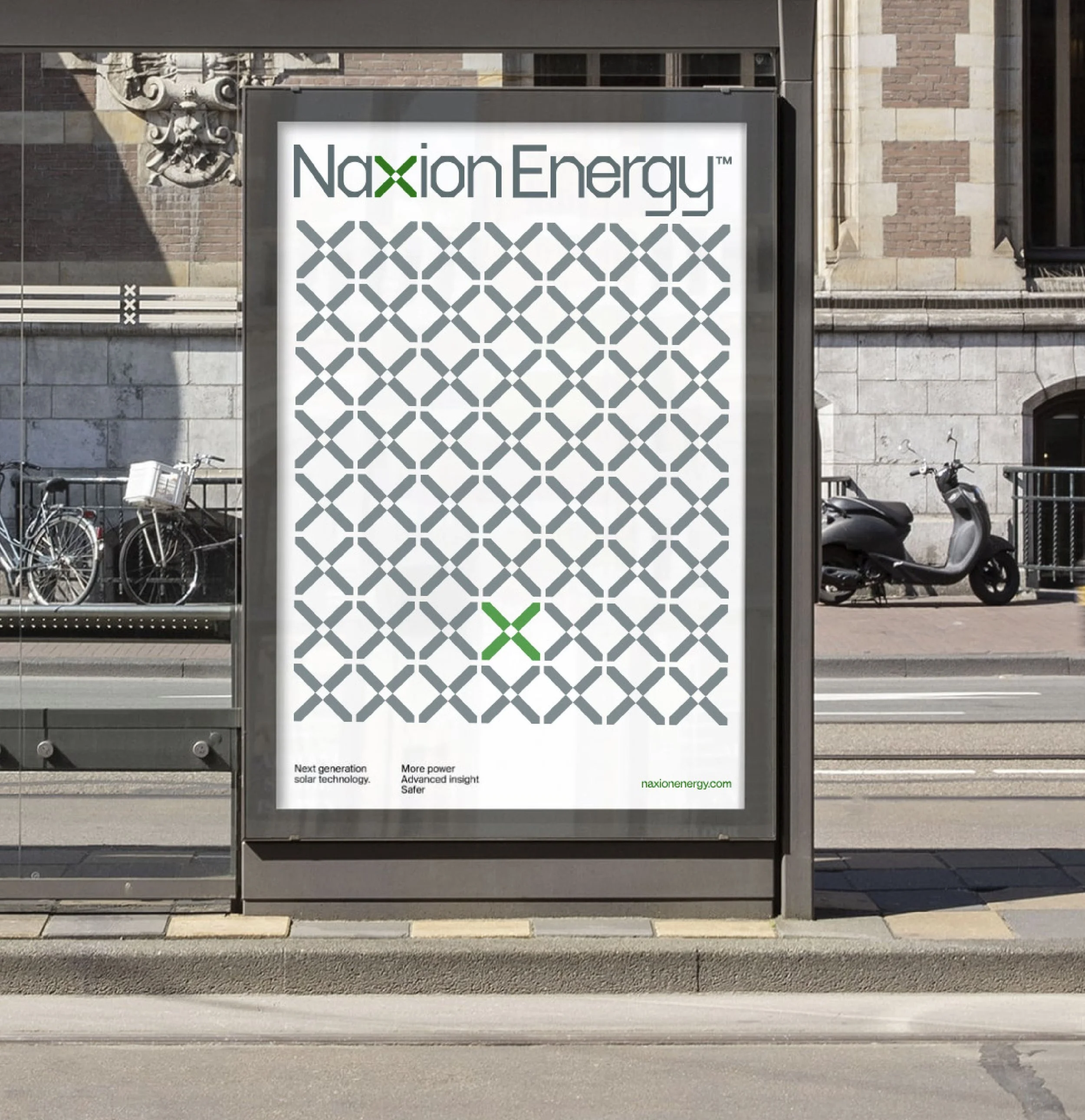 A billboard promoting Naxion Energy with text: next generation solar technology, more power, advanced insight, safer, in front of a historic brick building with bicycle racks and parked motorcycles.