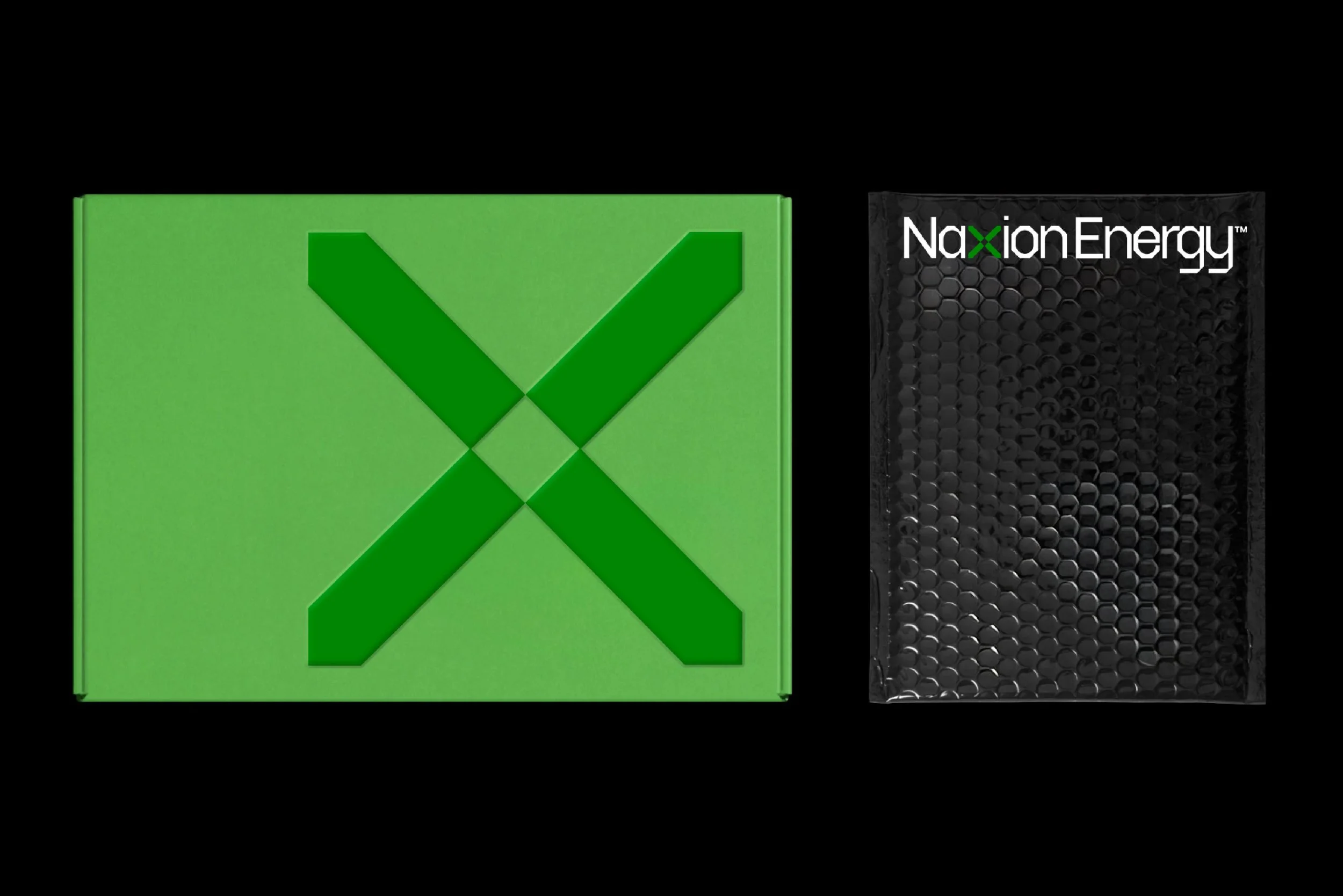 Close-up of a green box with a check mark symbol on it, positioned next to a black package with a textured surface and the text 'Naxon Energy' on it.